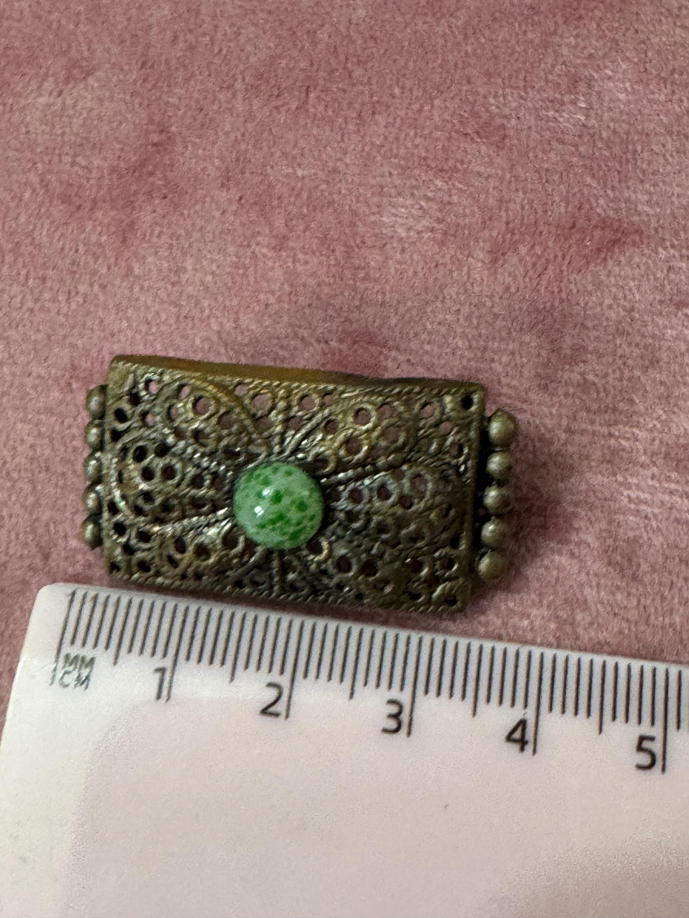 Antique Czech gold tone brass metal Brooch set with a peking glass green cabochon