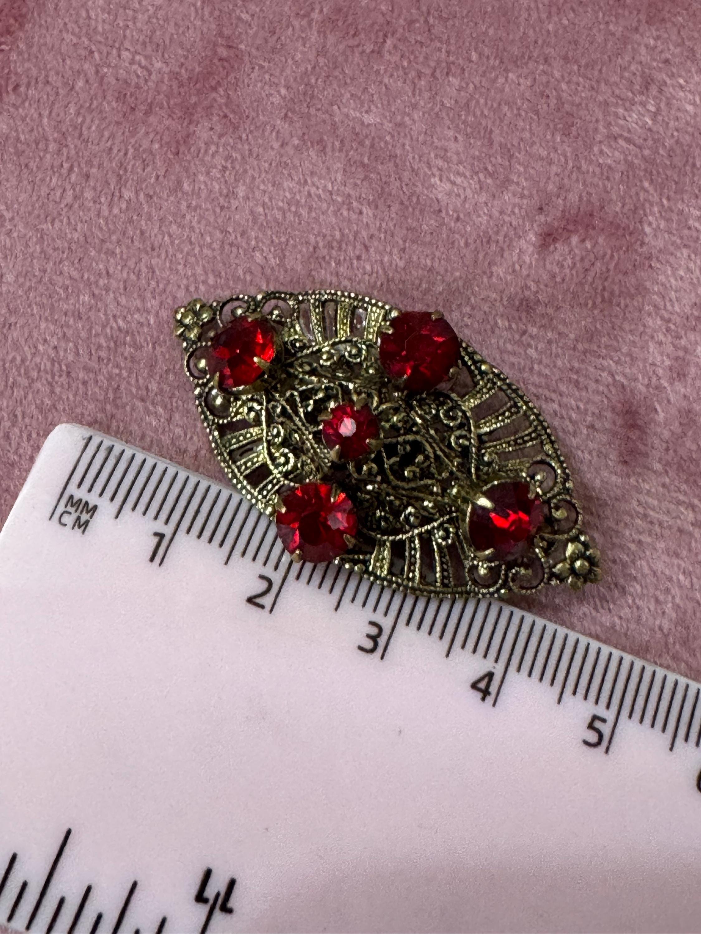 Antique Art Deco Czech brass gilt metal filigree brooch with red faux ruby glass paste rhinestones ornate