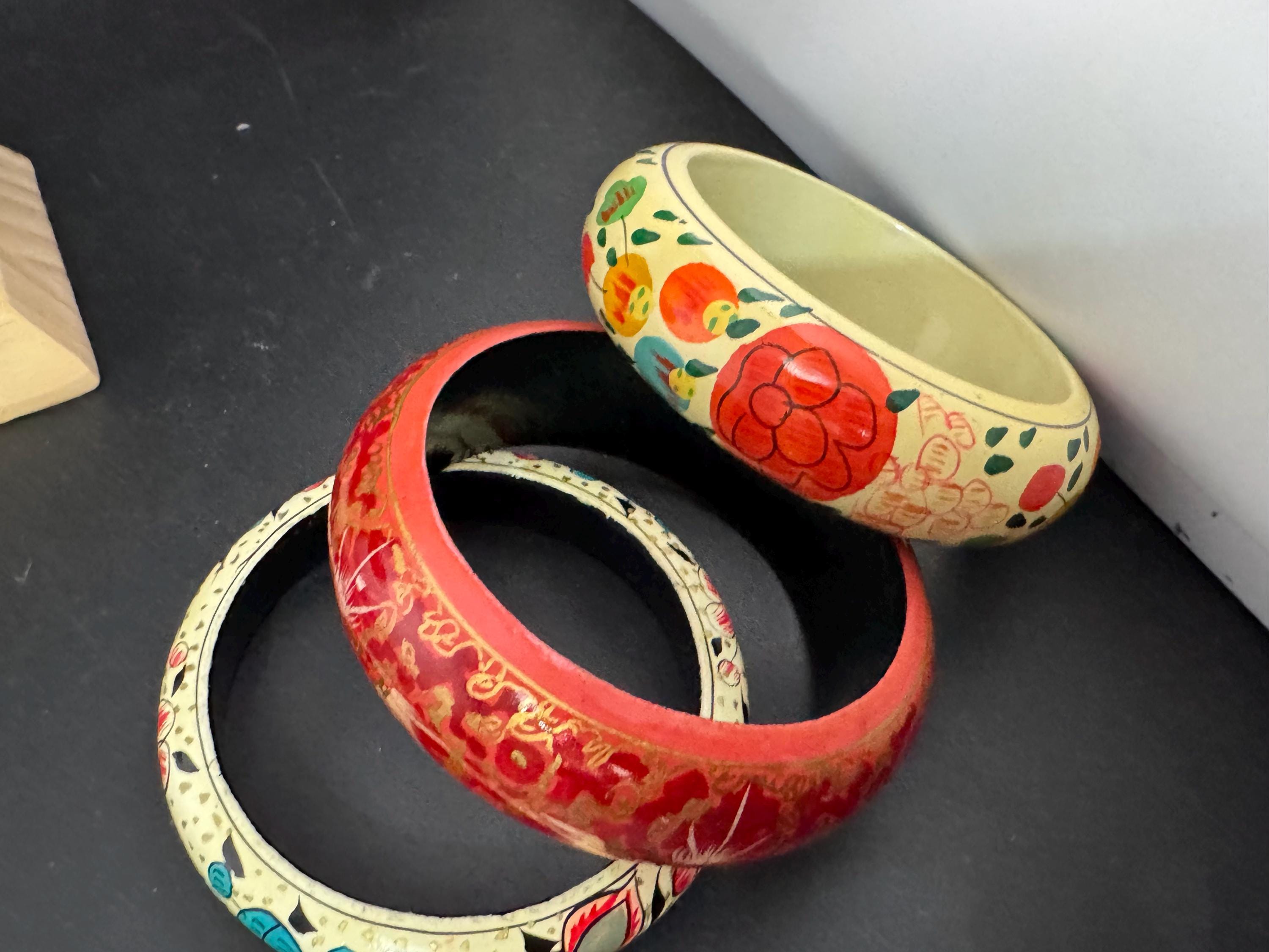 A curated set of 3 gold red cream toned wood or paper mache wide cuff bangle bracelets stacking layering Vintage retro