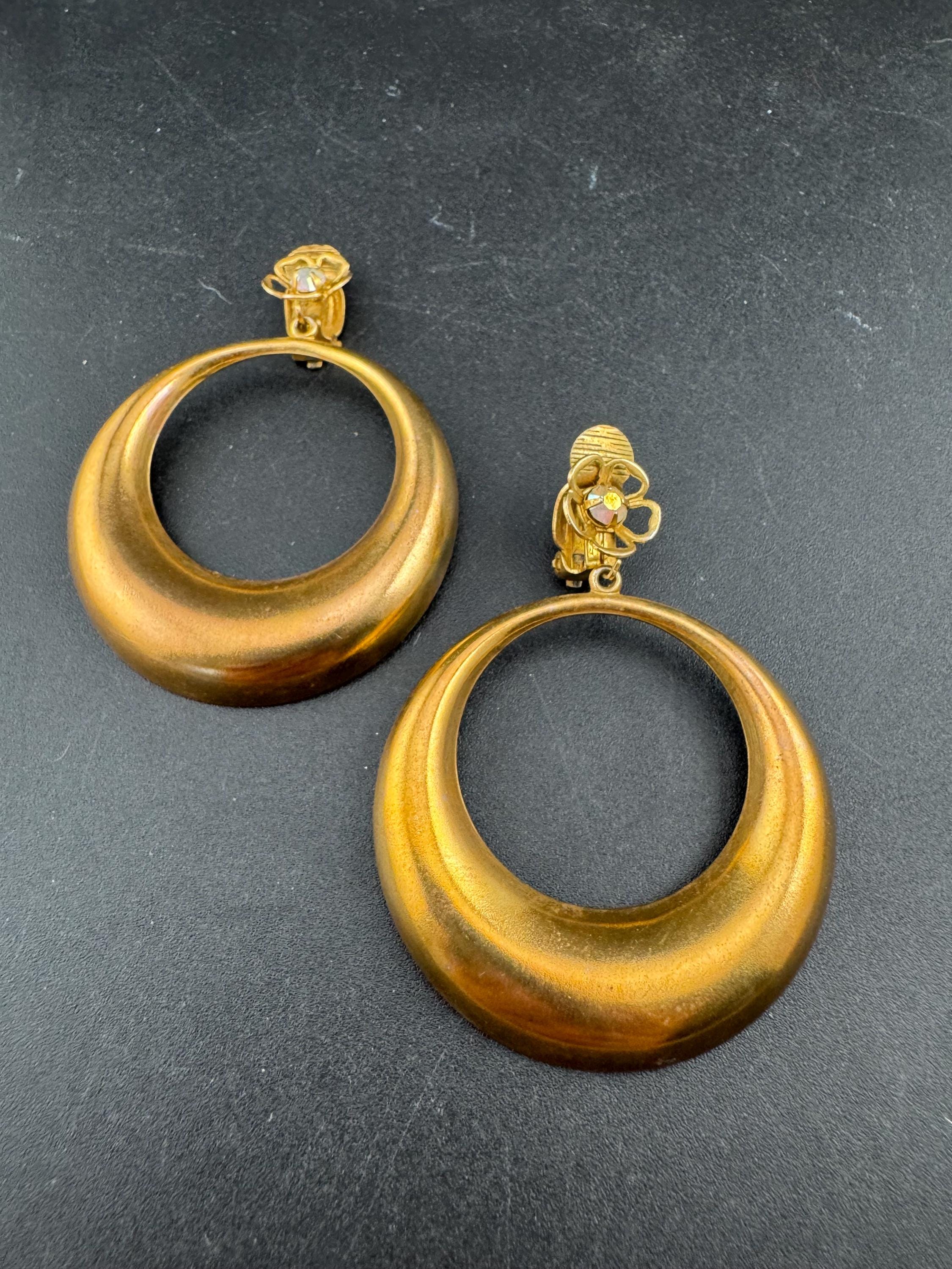 Vintage 1960s brass gold tone big loop clip on earrings set with aurora borealis rhinestone.