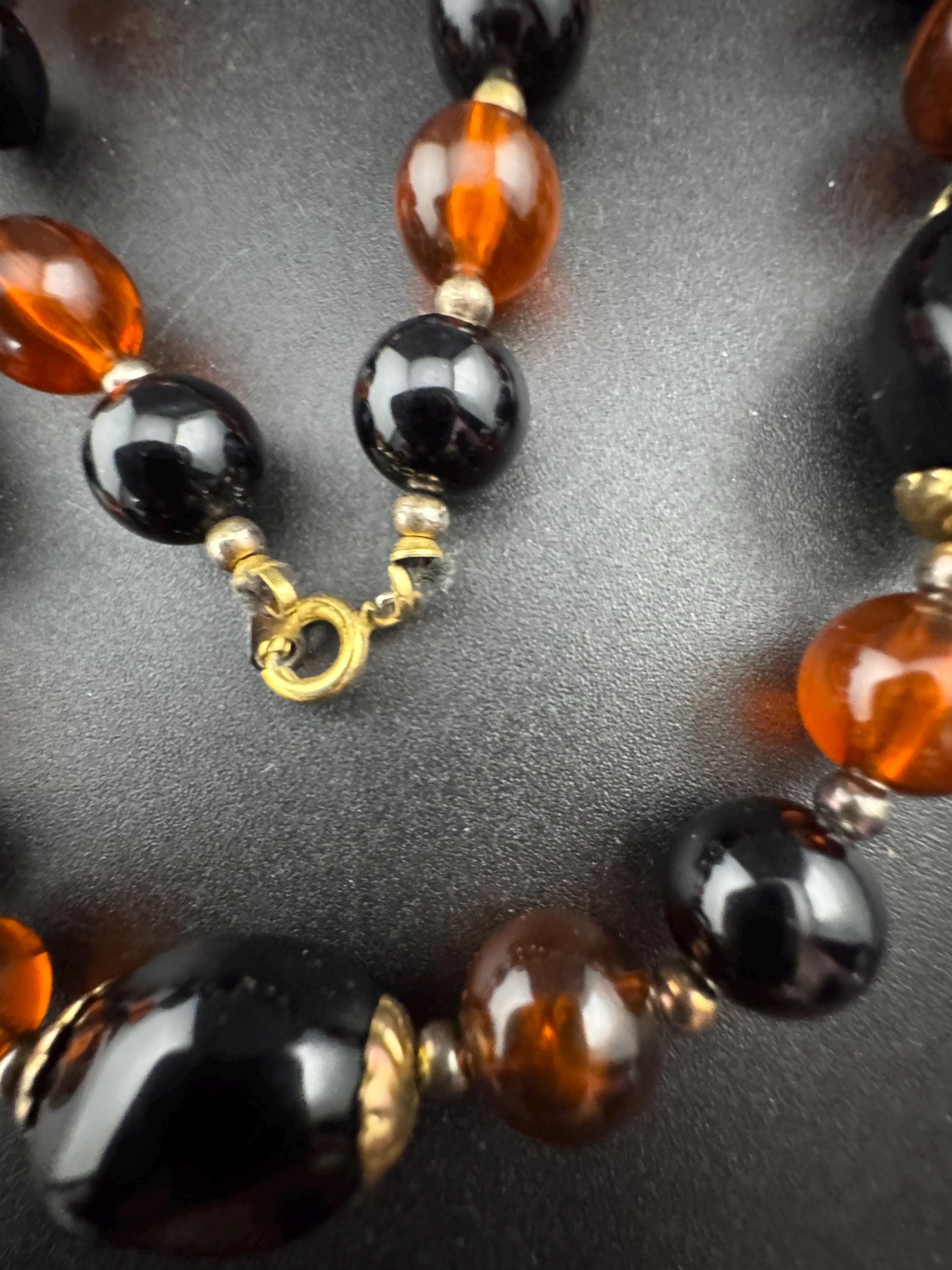 Long brown plastic beaded necklace with black and gold beads 70s early 80s , 78cm