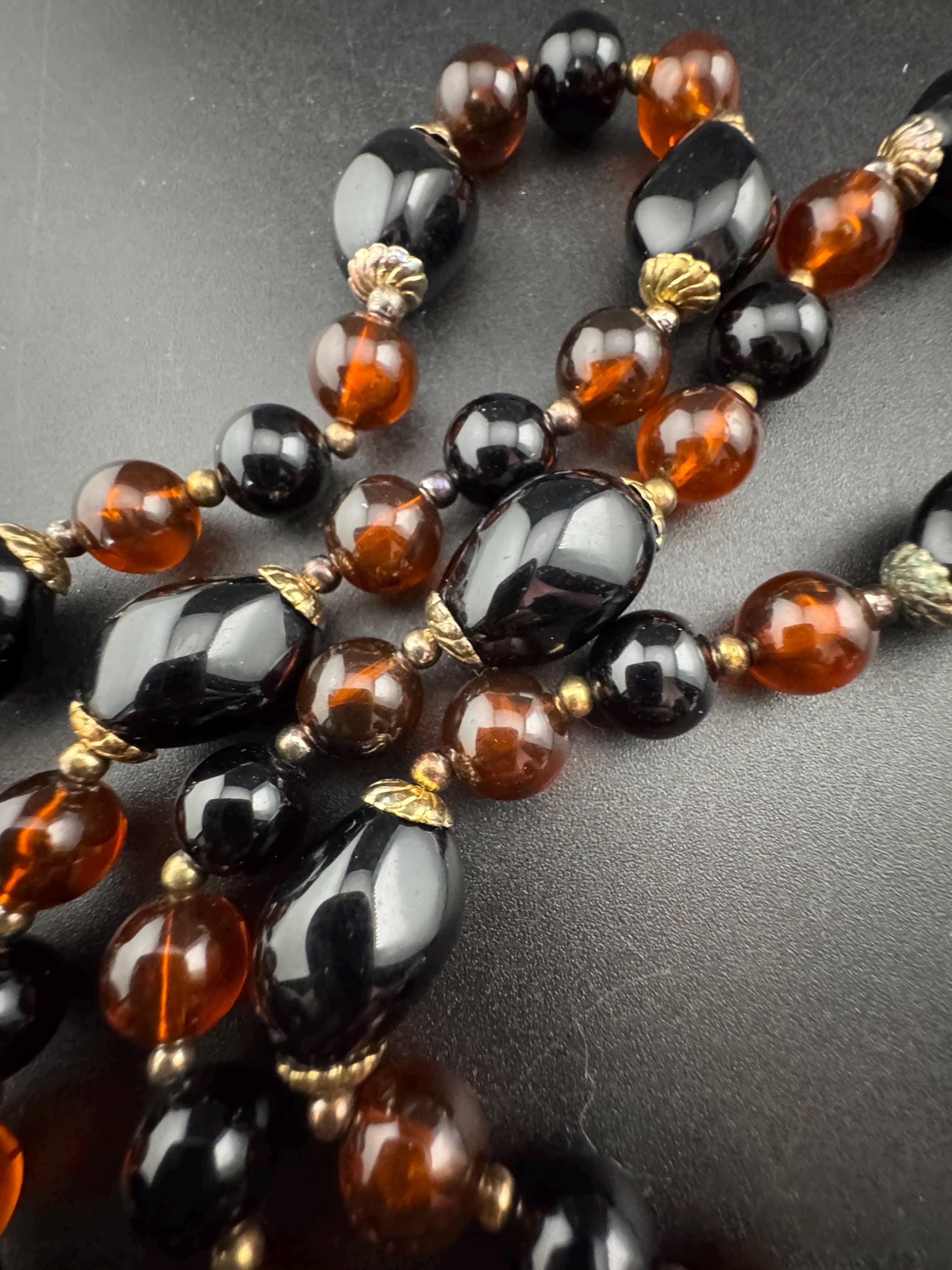 Long brown plastic beaded necklace with black and gold beads 70s early 80s , 78cm