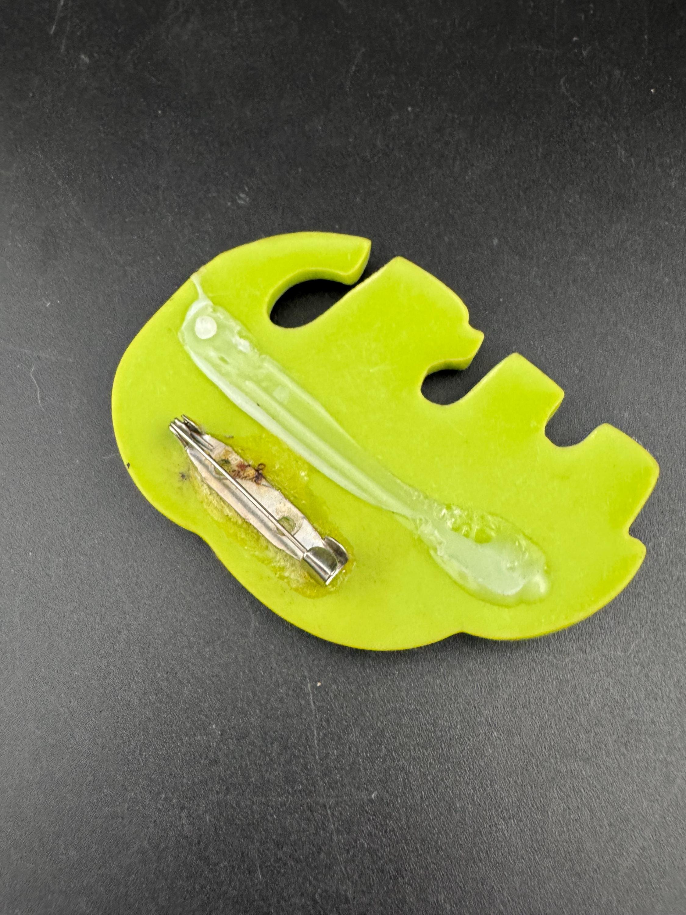big lime green elephant and baby brooch inset with abalone shell, early plastic 1960s