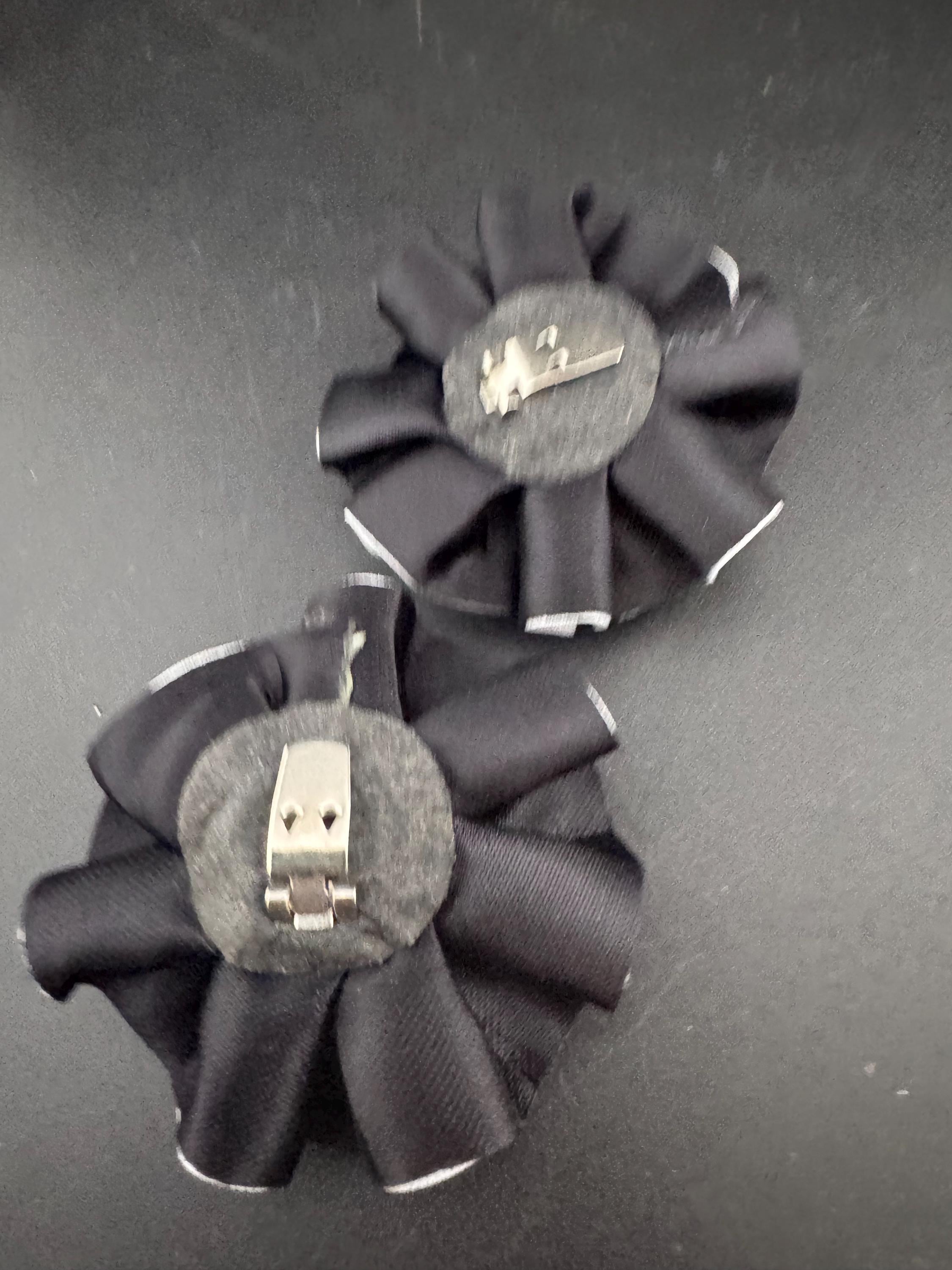 Vintage pair of black and white ribbon flower twist Pom Pom shoe clips trims 1980s