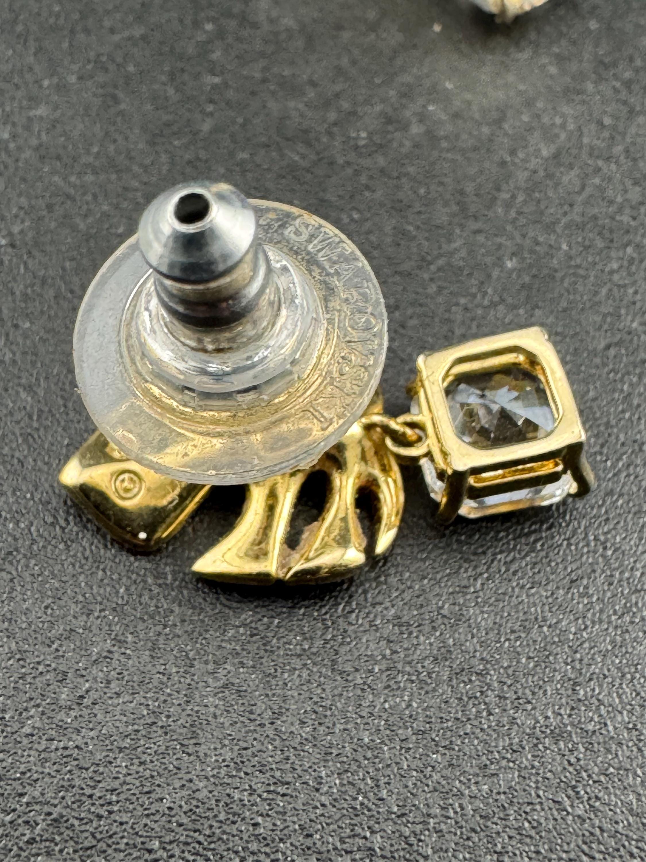 Signed Swarovski gold plated small clear crystal palm leaf pierced drop earrings