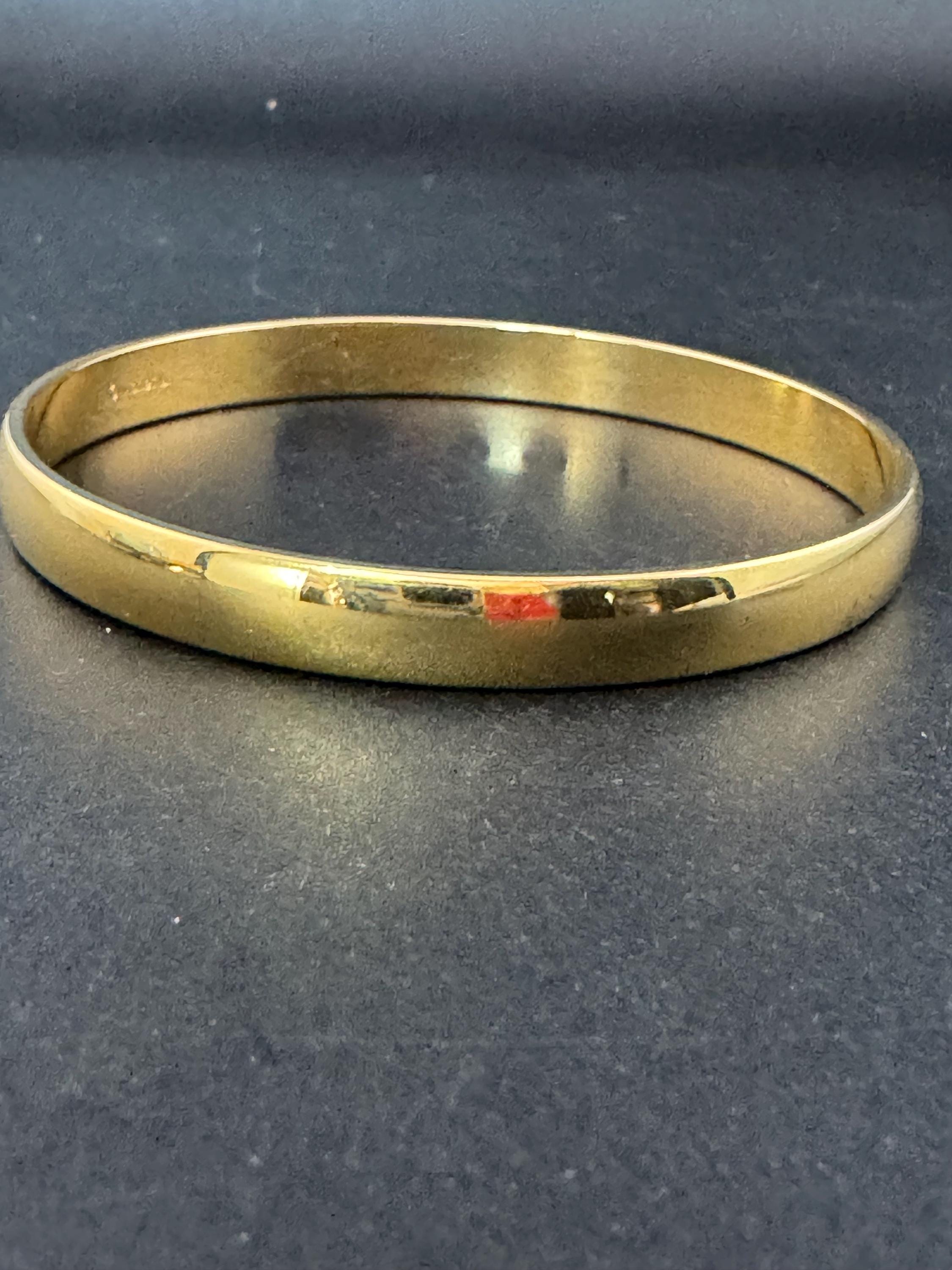 Vintage designer MONET signed glossy gold tone 1cm wide fixed bangle bracelet