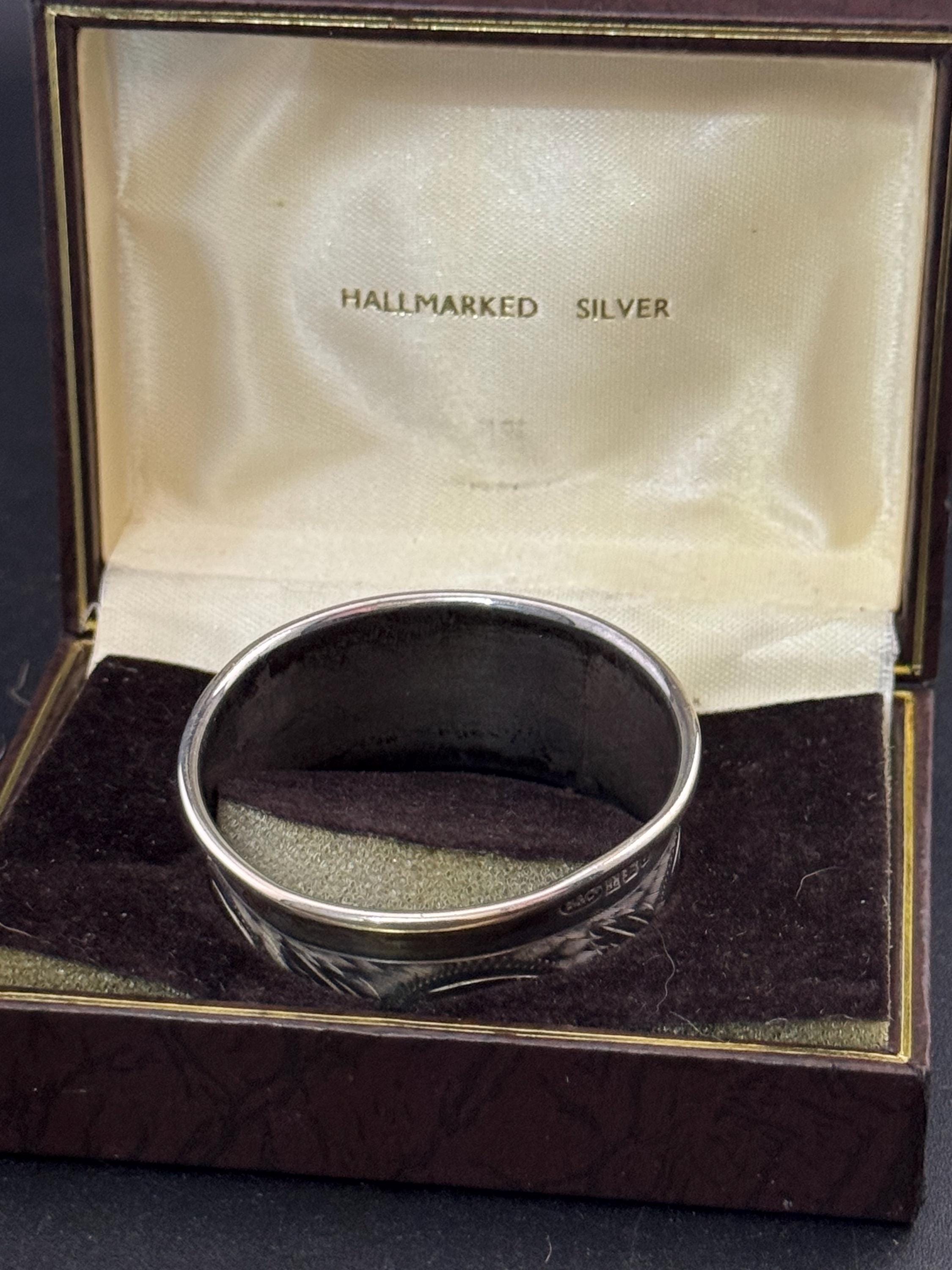 925 sterling silver napkin ring with a black cartouche for monogramming in a presentation box