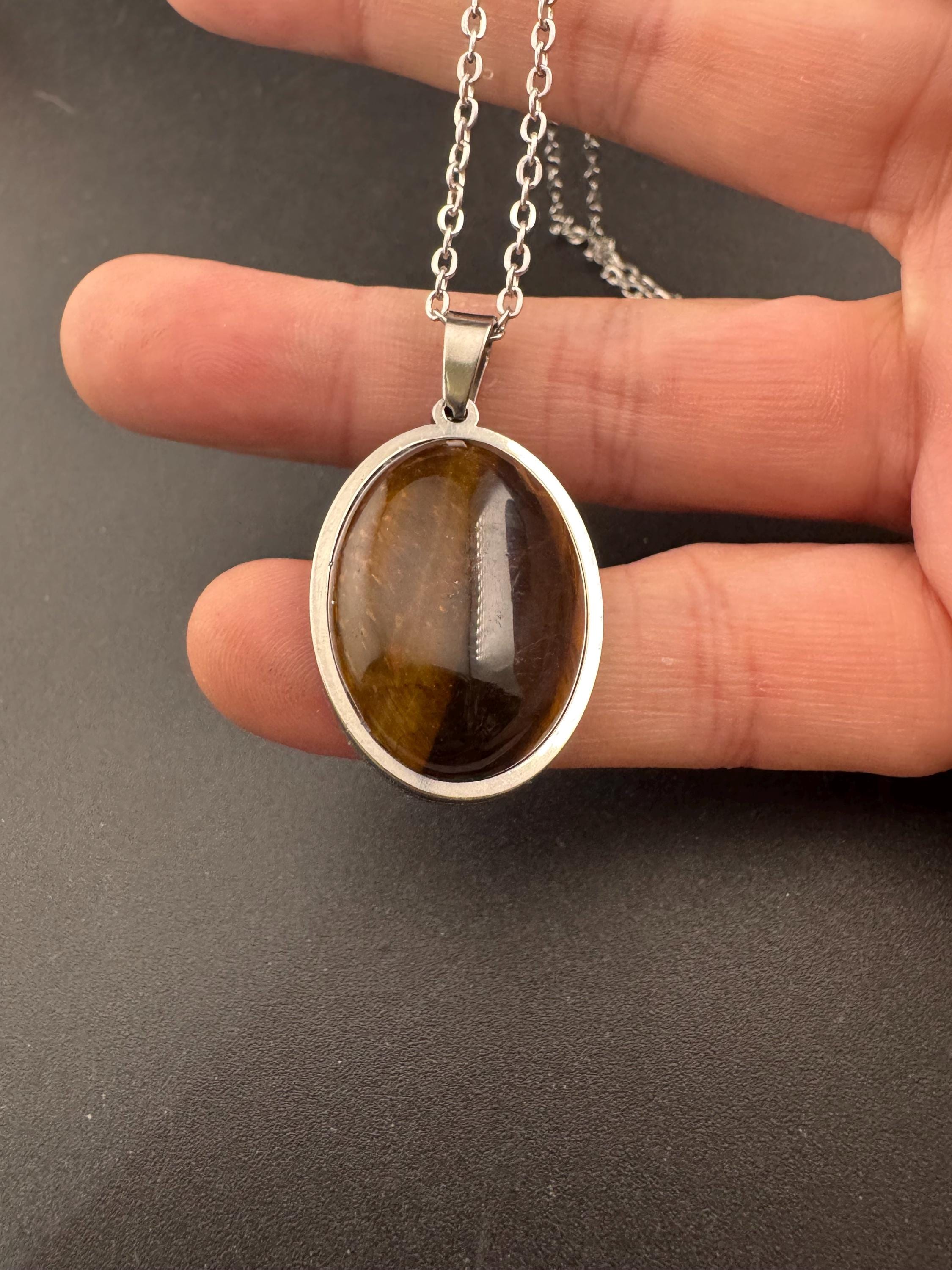 Oval natural tigers eye brown gemstone pendant in non tarnish stainless steel on a 49cm SS chain