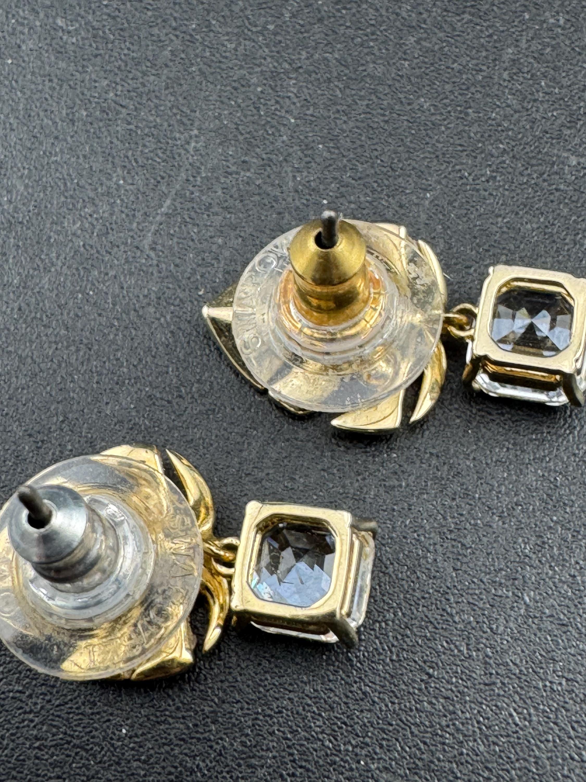 Signed Swarovski gold plated small clear crystal palm leaf pierced drop earrings