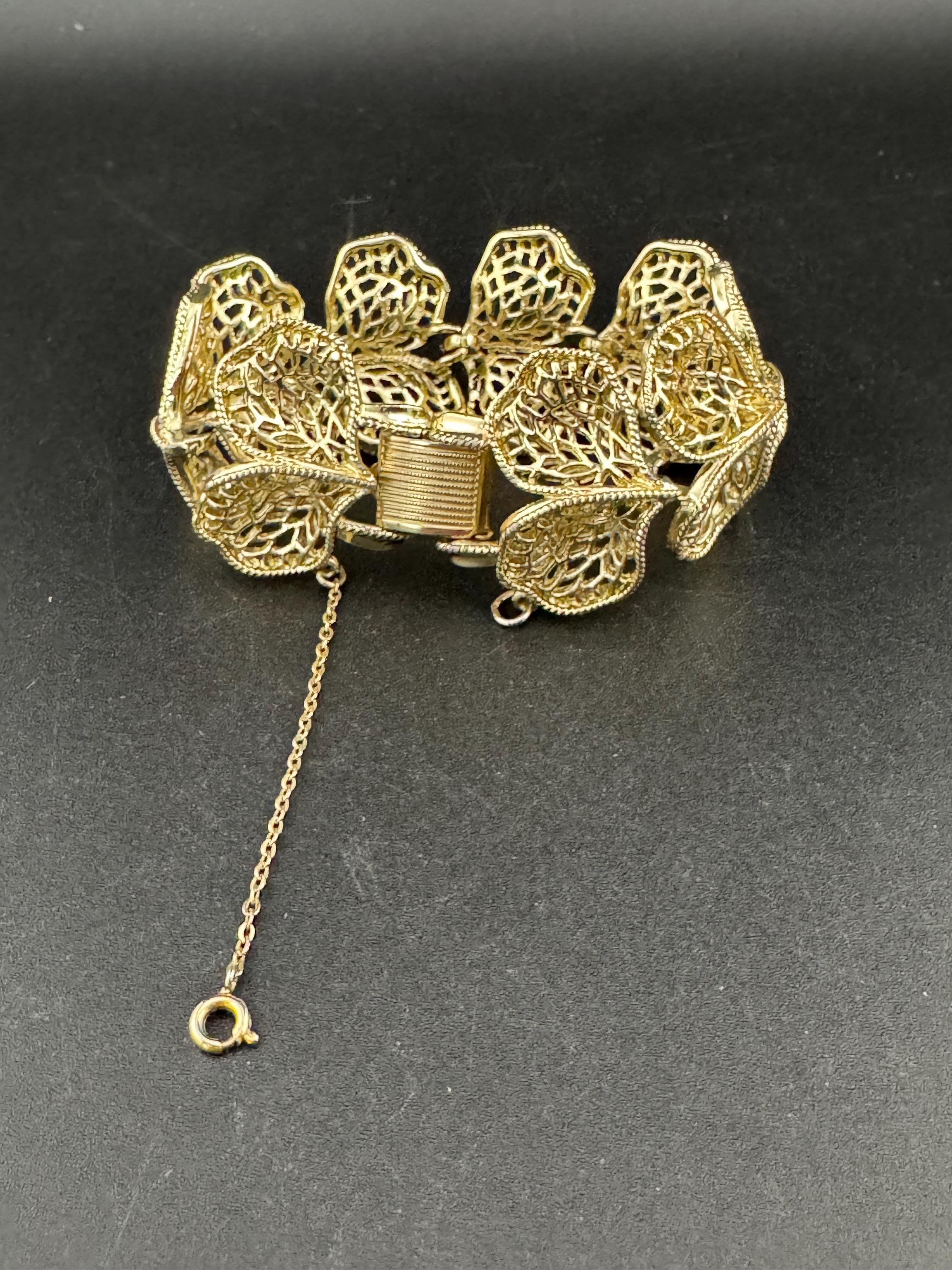 Mid century vintage very wide gold tone floral leaf bracelet,  panel link openwork with safety chain