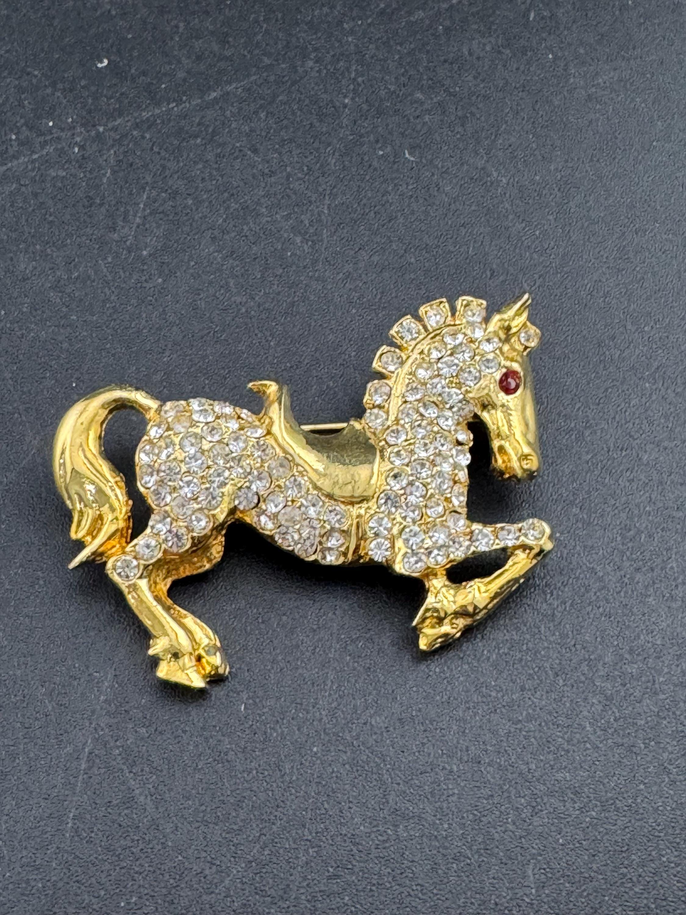 Vintage clear crystal rhinestone horse brooch, gold tone
