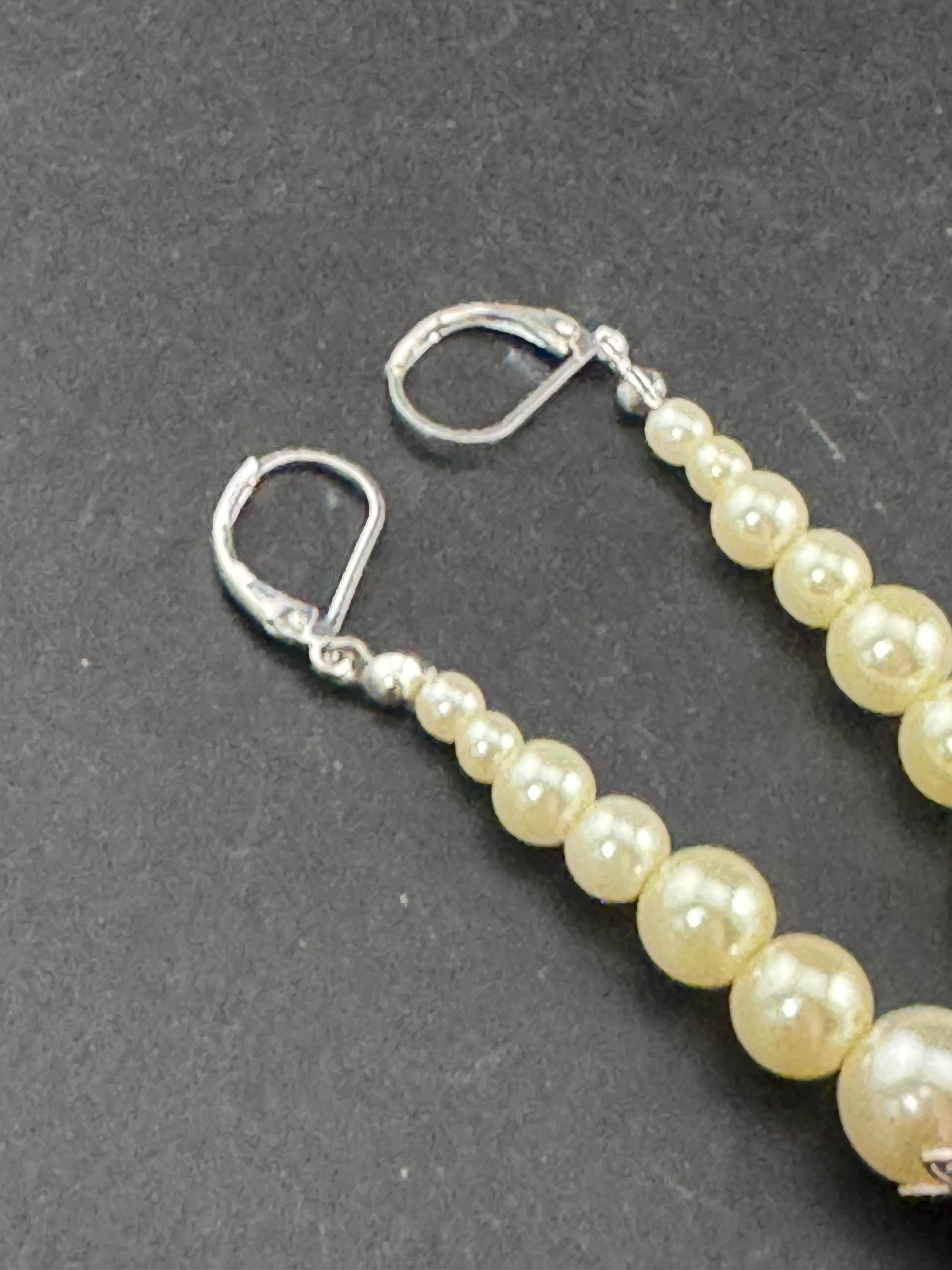 Retro Silver tone long plastic beaded faux pearl dangly drop earrings pierced ears with clear diamanté