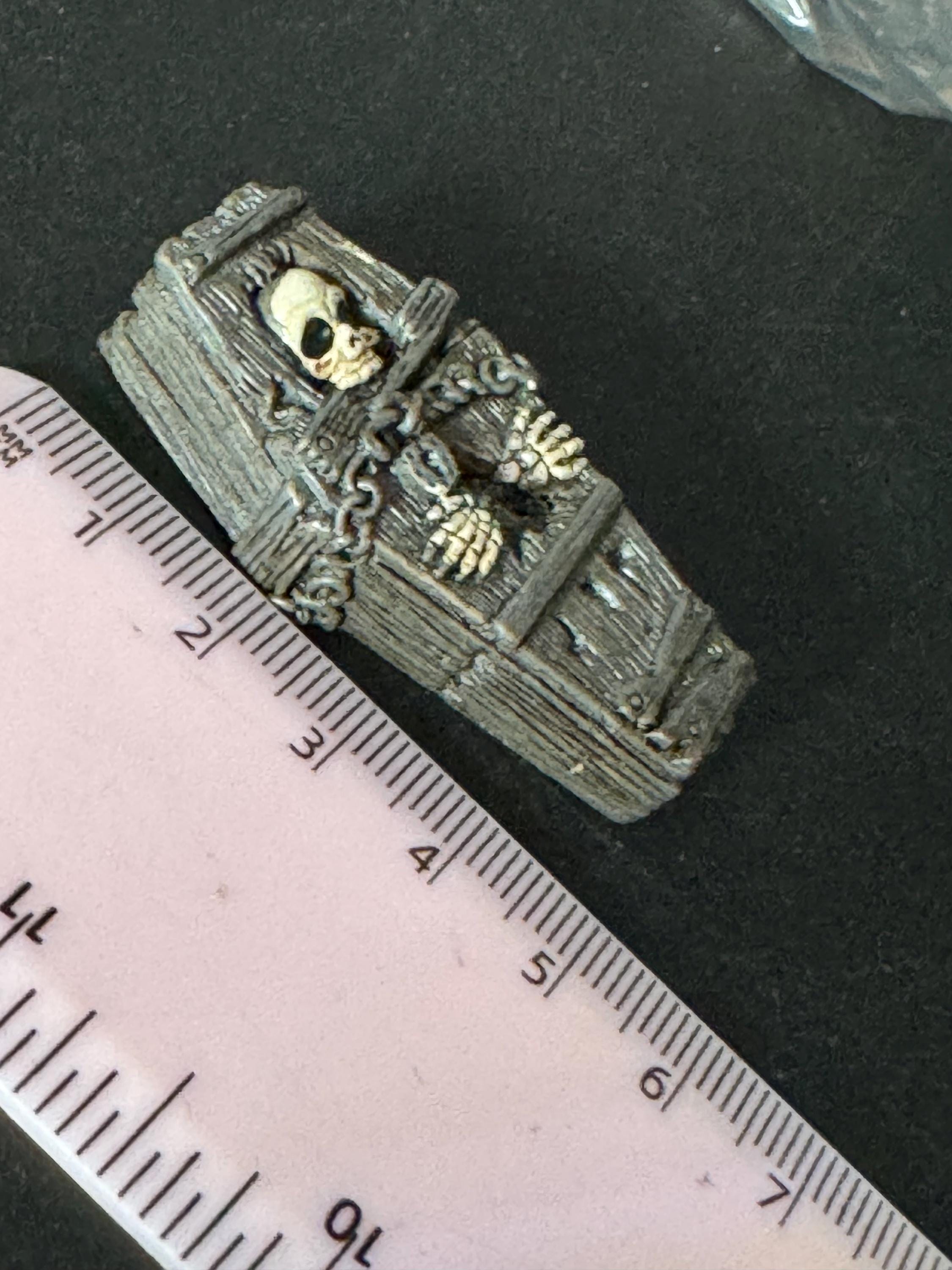 Miniature spooky Halloween skeleton in a coffin cake topper decorations, craft scenery, reusable plastic