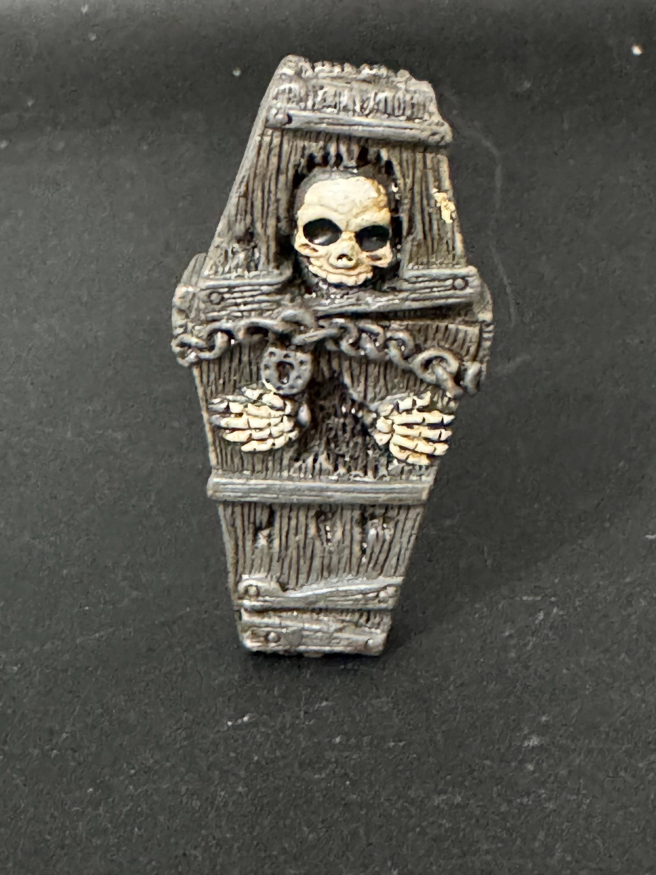 Miniature spooky Halloween skeleton in a coffin cake topper decorations, craft scenery, reusable plastic