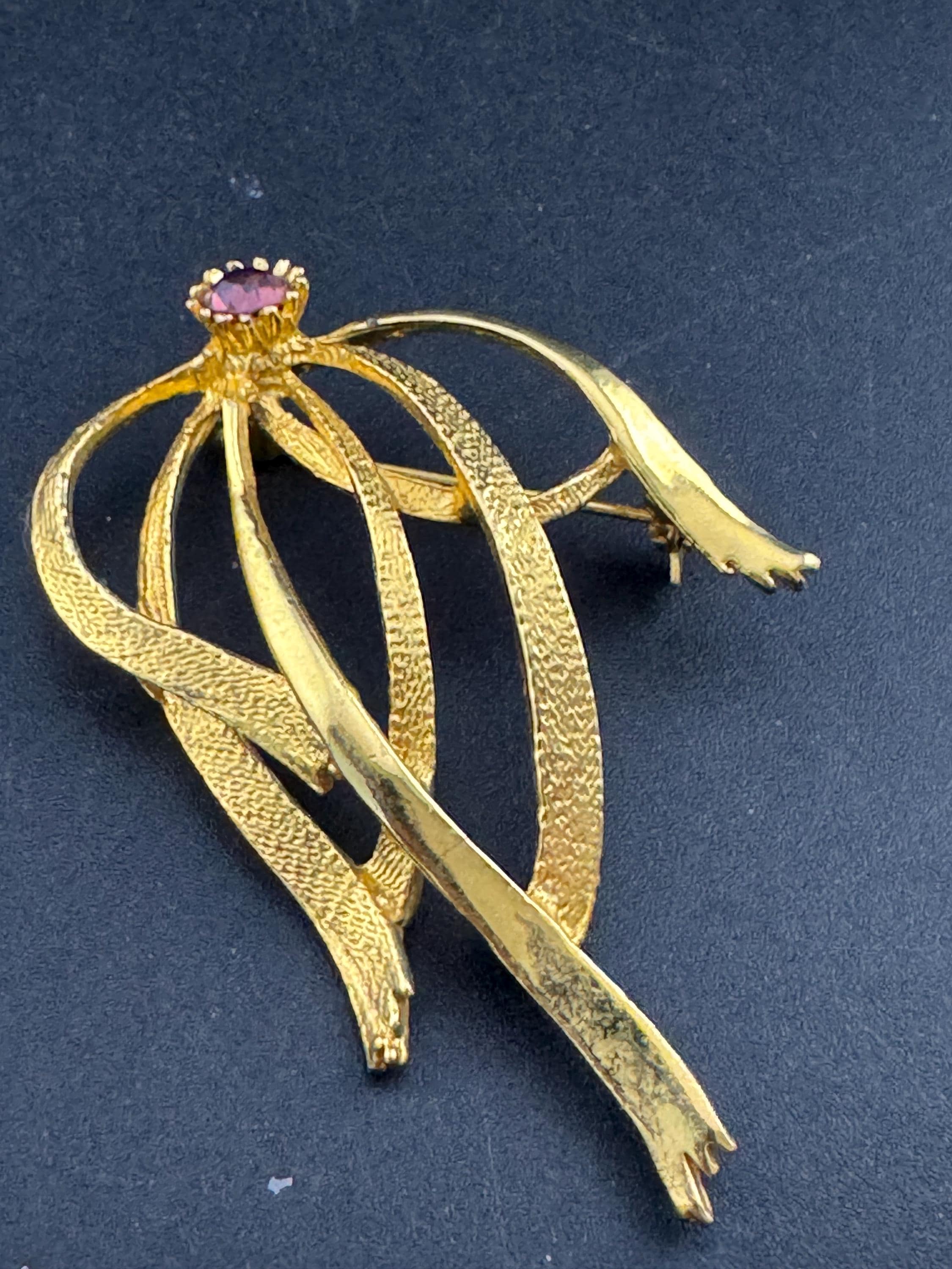 HOLLYWOOD signed abstract swirl brooch with amethyst rhinestone