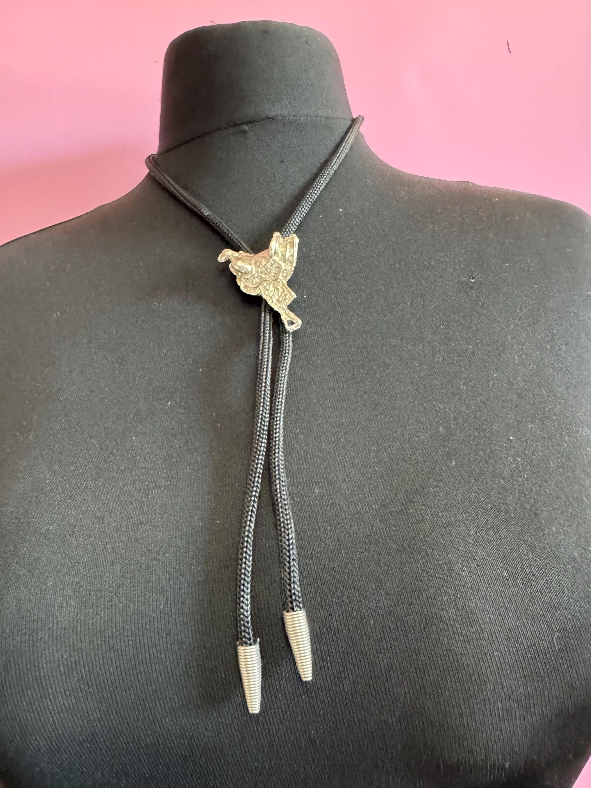 Retro western style horse saddle bolo tie with black woven leather