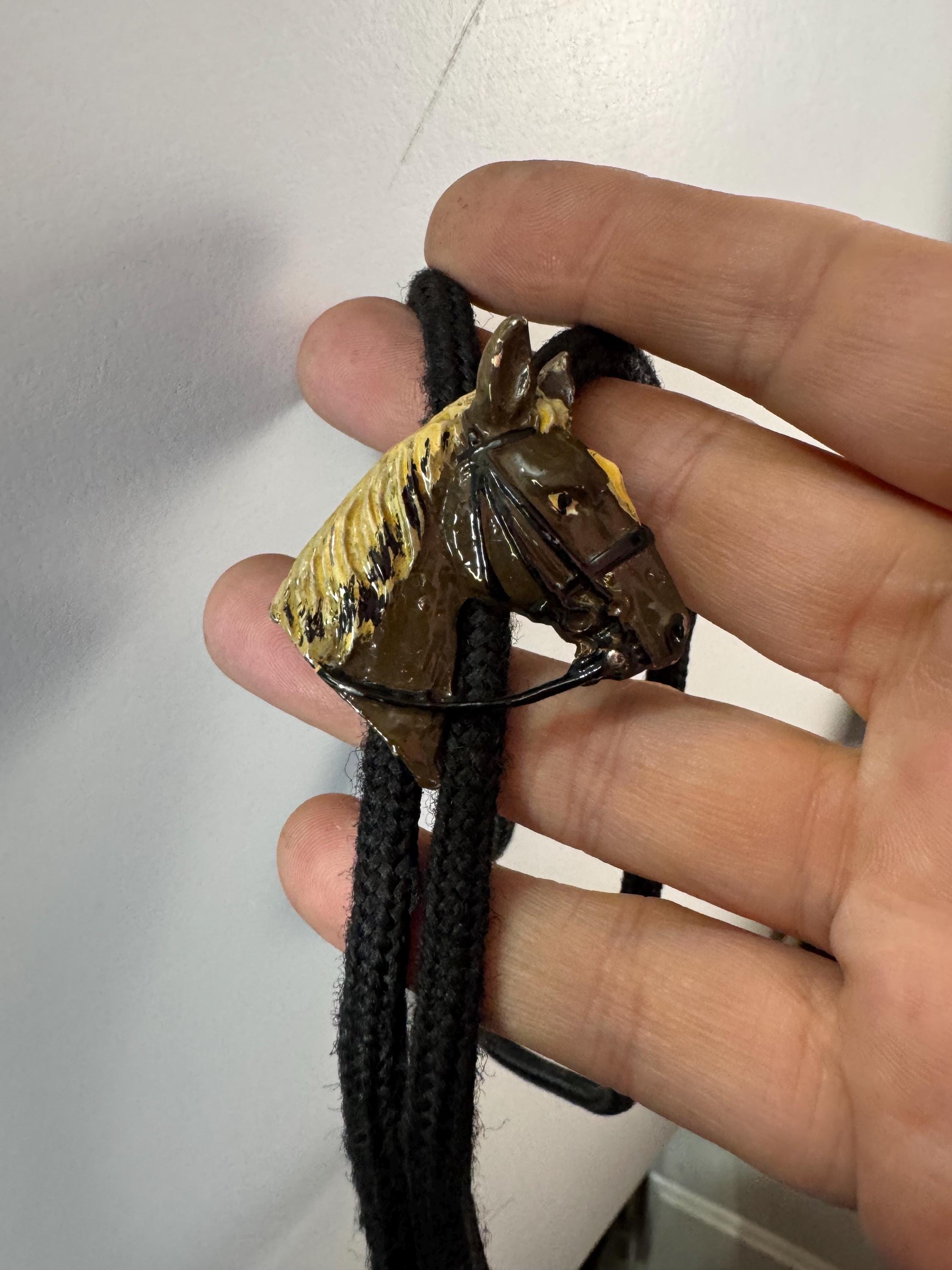 Retro western style brown enamel horse bolo tie with black woven cord