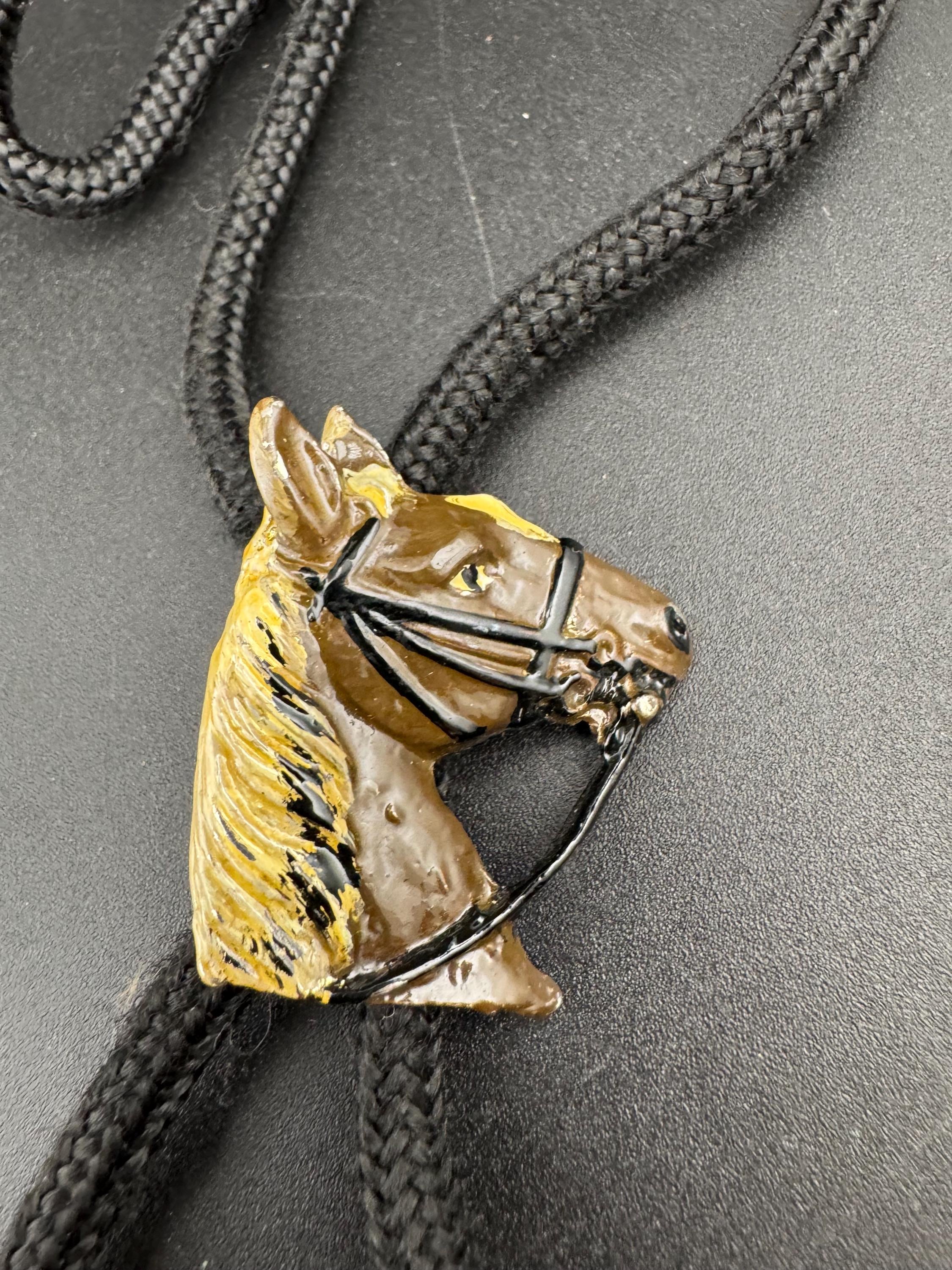 Retro western style brown enamel horse bolo tie with black woven cord