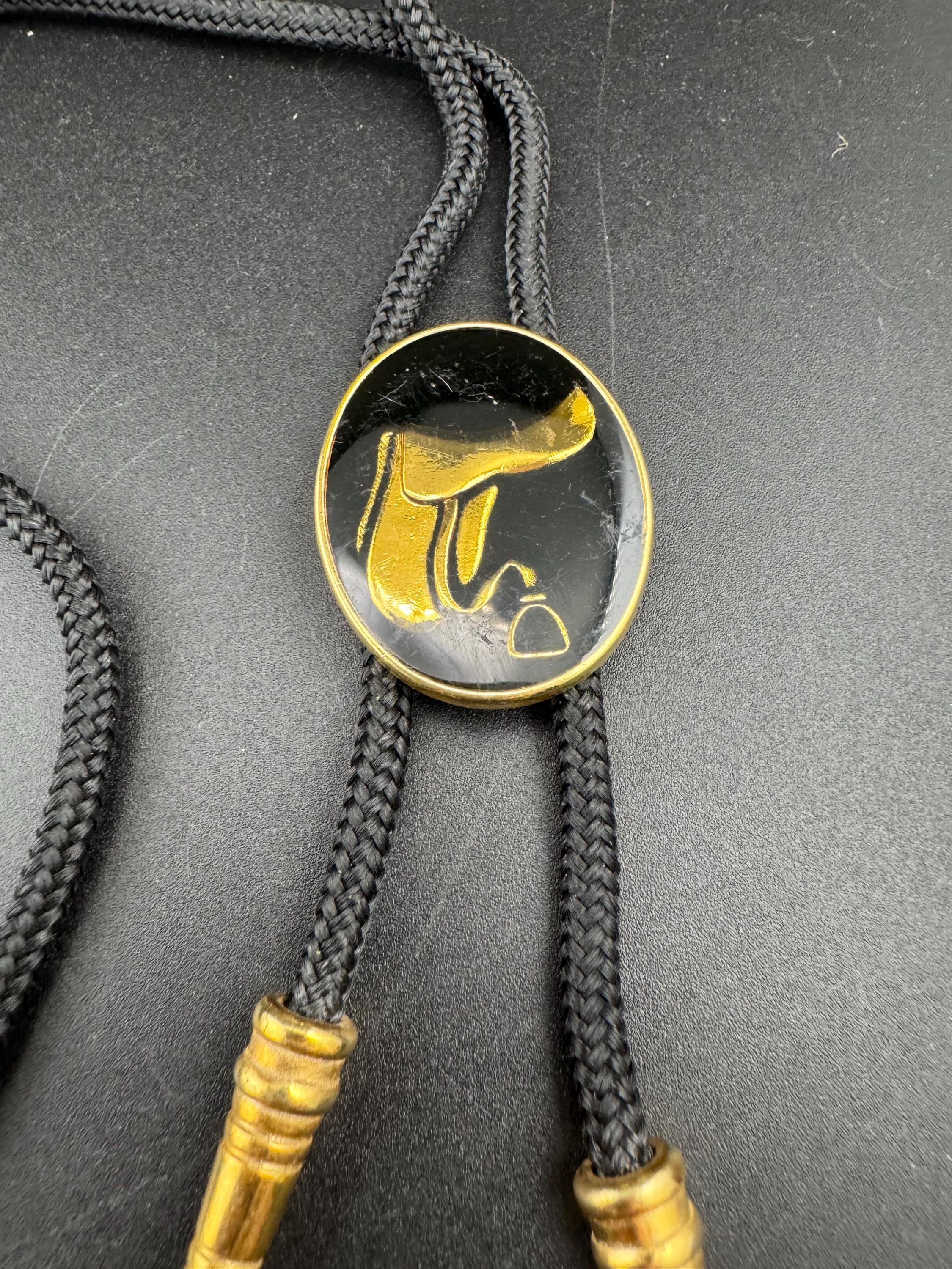 Retro western style gold black enamel horse saddle bolo tie with black woven cord