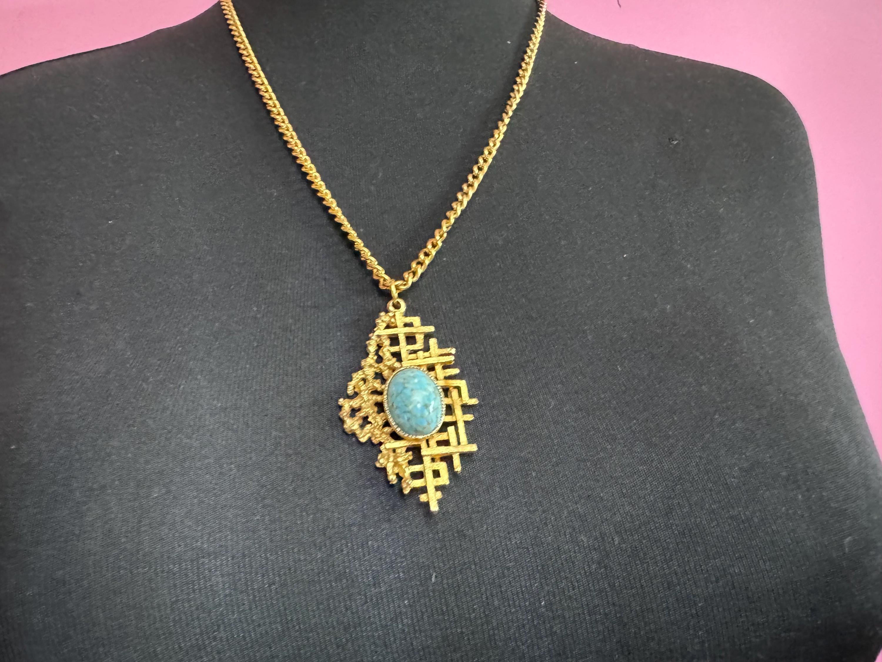 Vintage gold tone brutalist pendant with faux turquoise oval cabochon