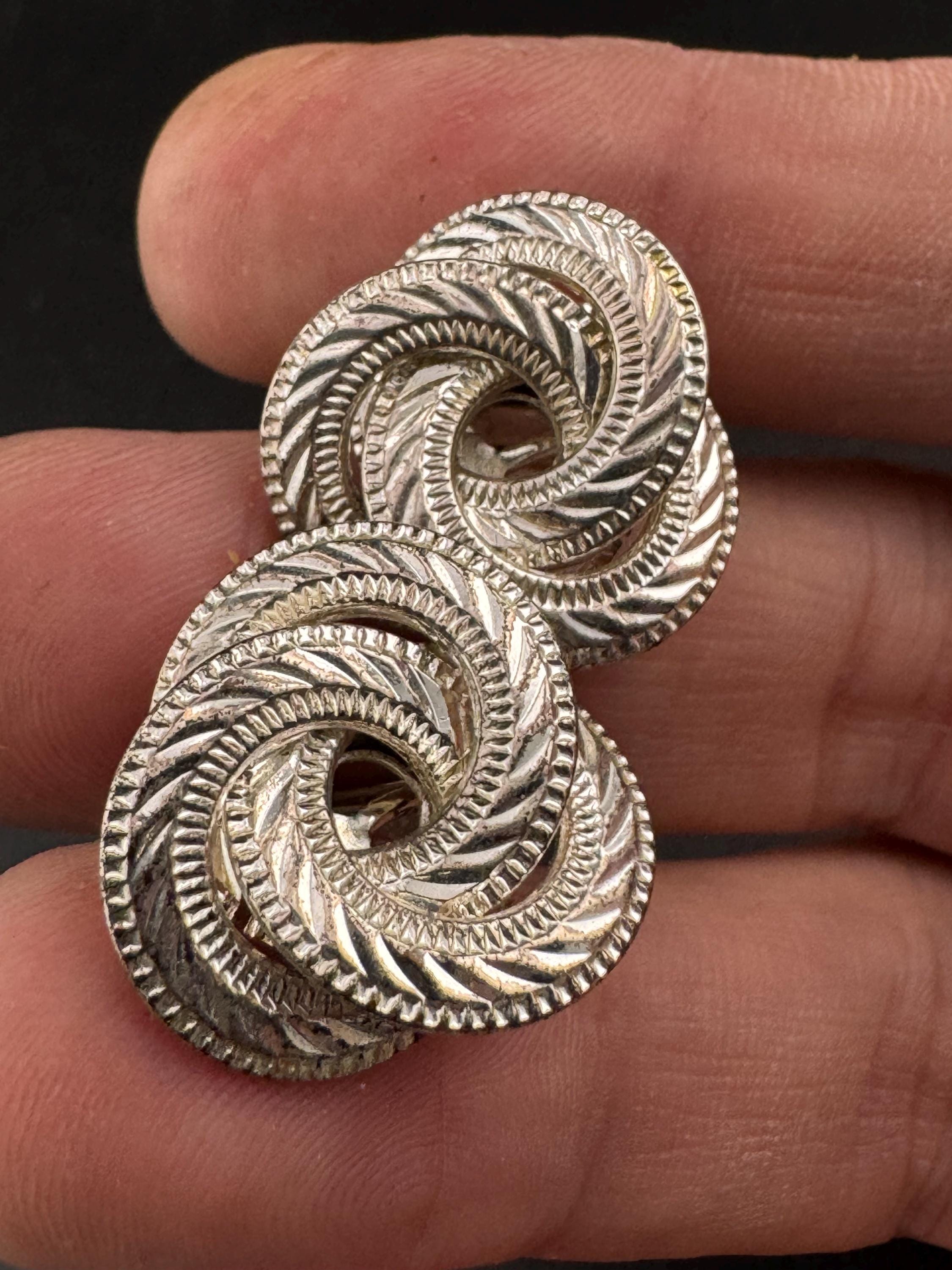 Signed NAPIER swirl knot clip on earrings, silver tone designer