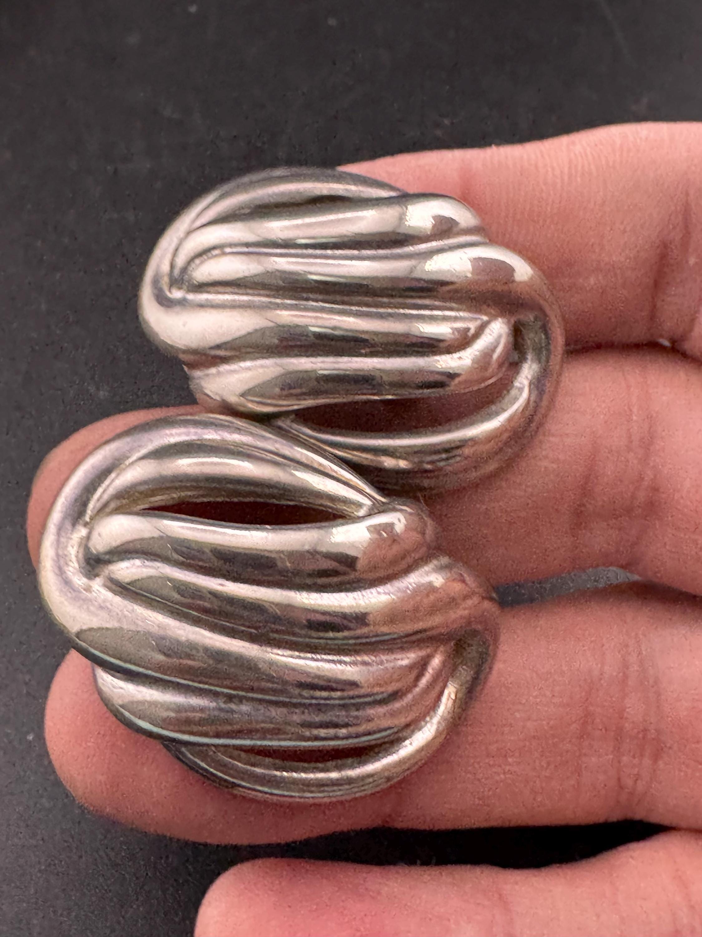 Vintage oversized silver metal swirl clip on earrings, 1980s