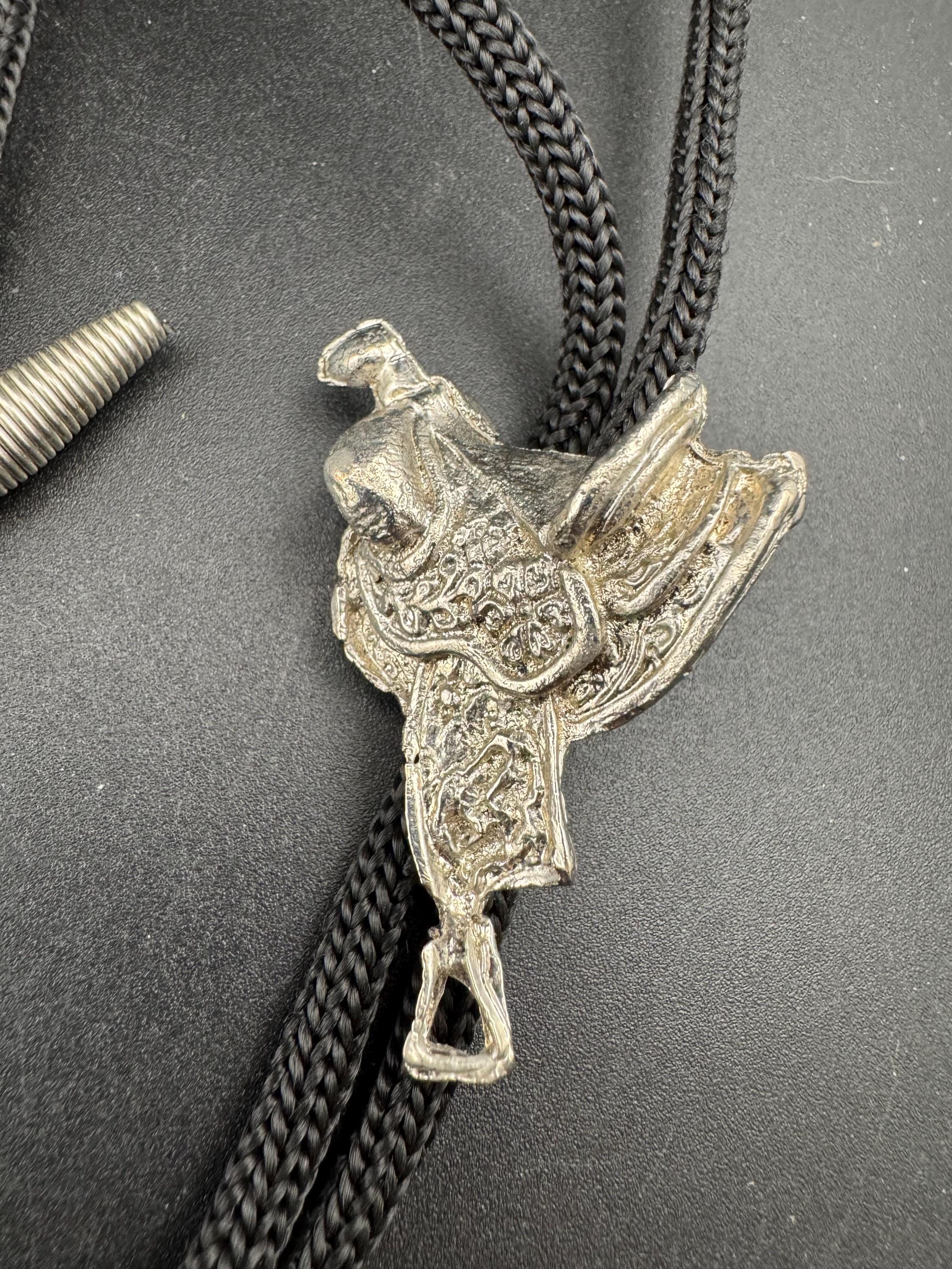 Retro western style horse saddle bolo tie with black woven leather