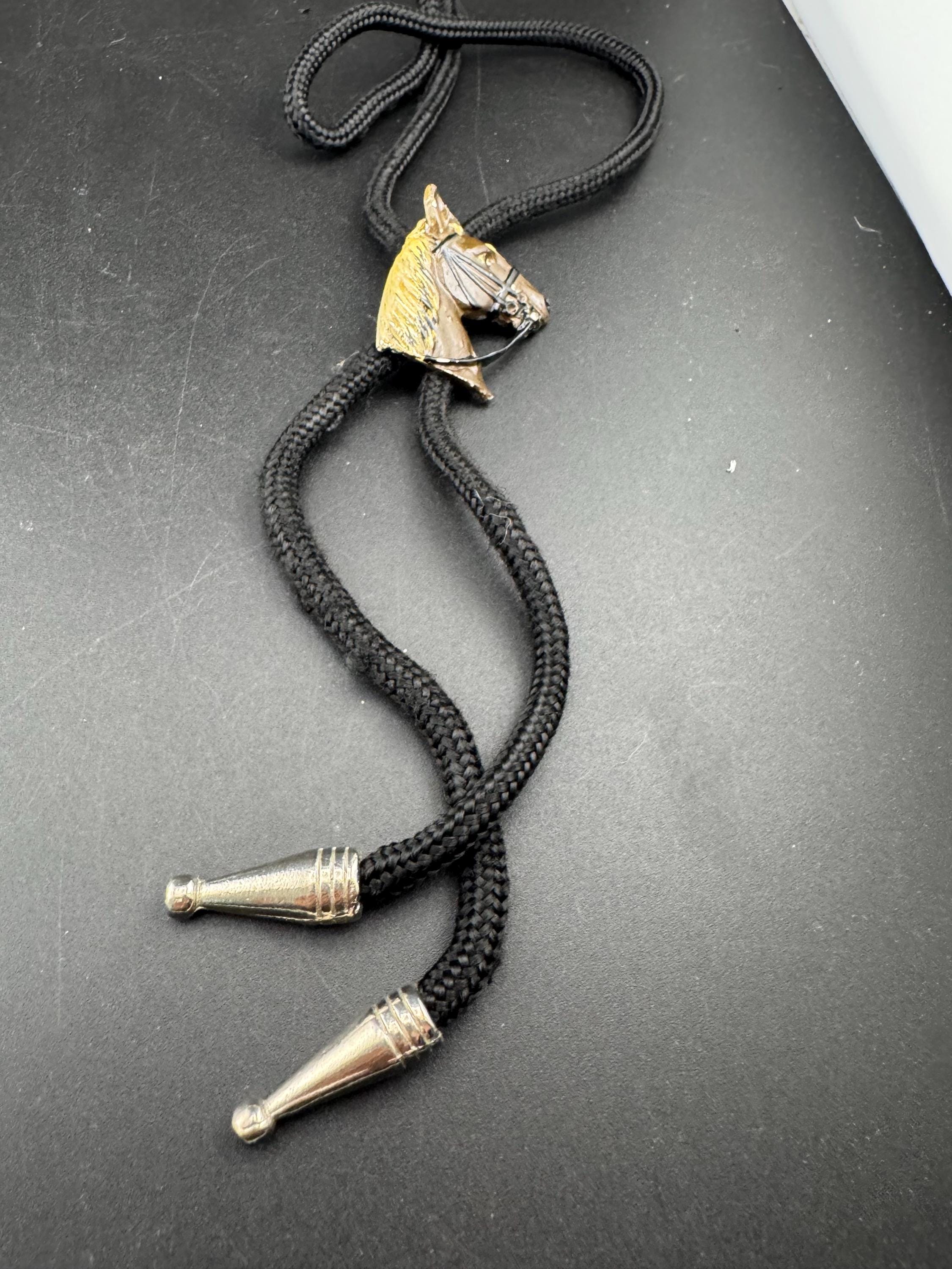 Retro western style brown enamel horse bolo tie with black woven cord