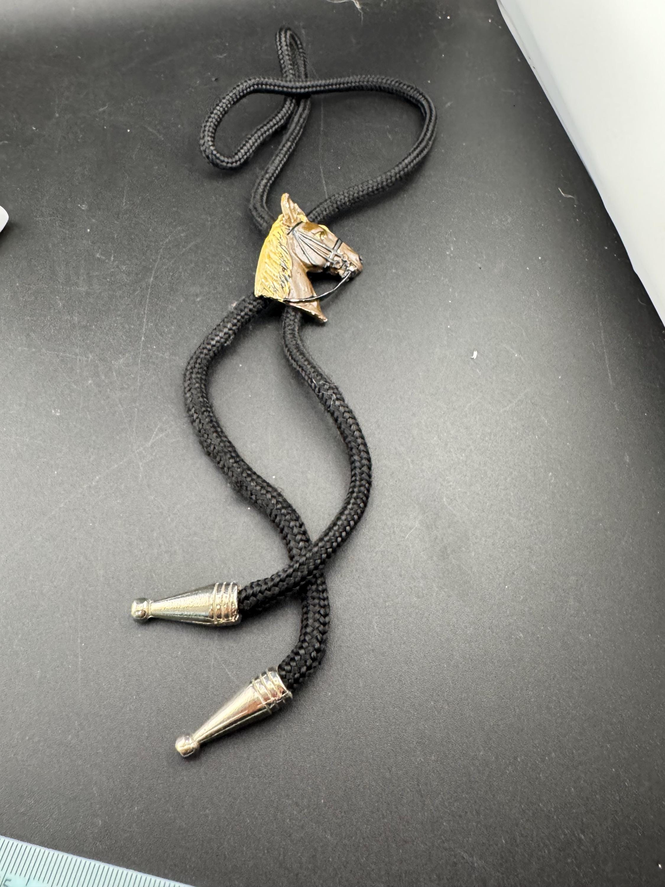Retro western style brown enamel horse bolo tie with black woven cord