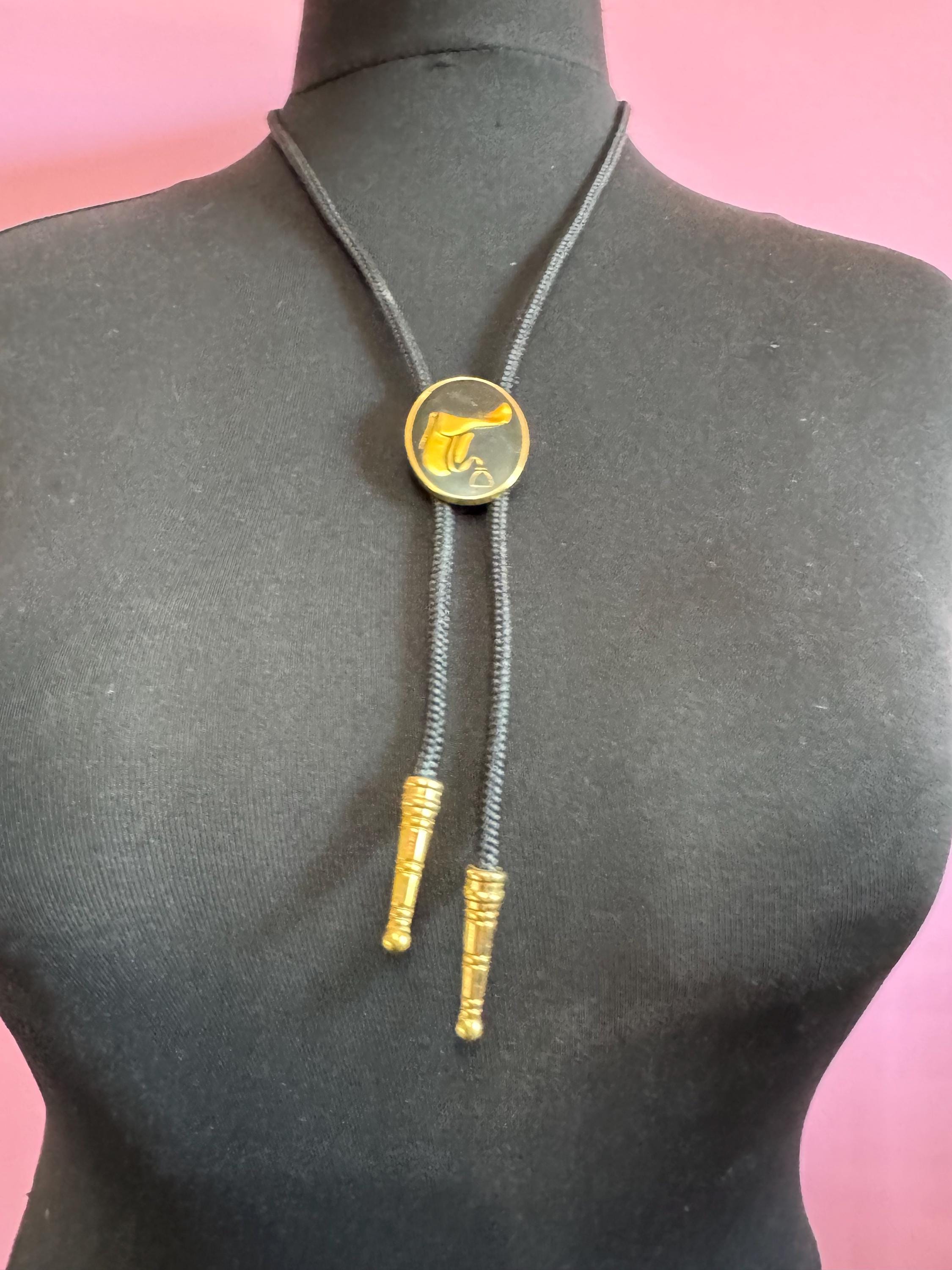 Retro western style gold black enamel horse saddle bolo tie with black woven cord
