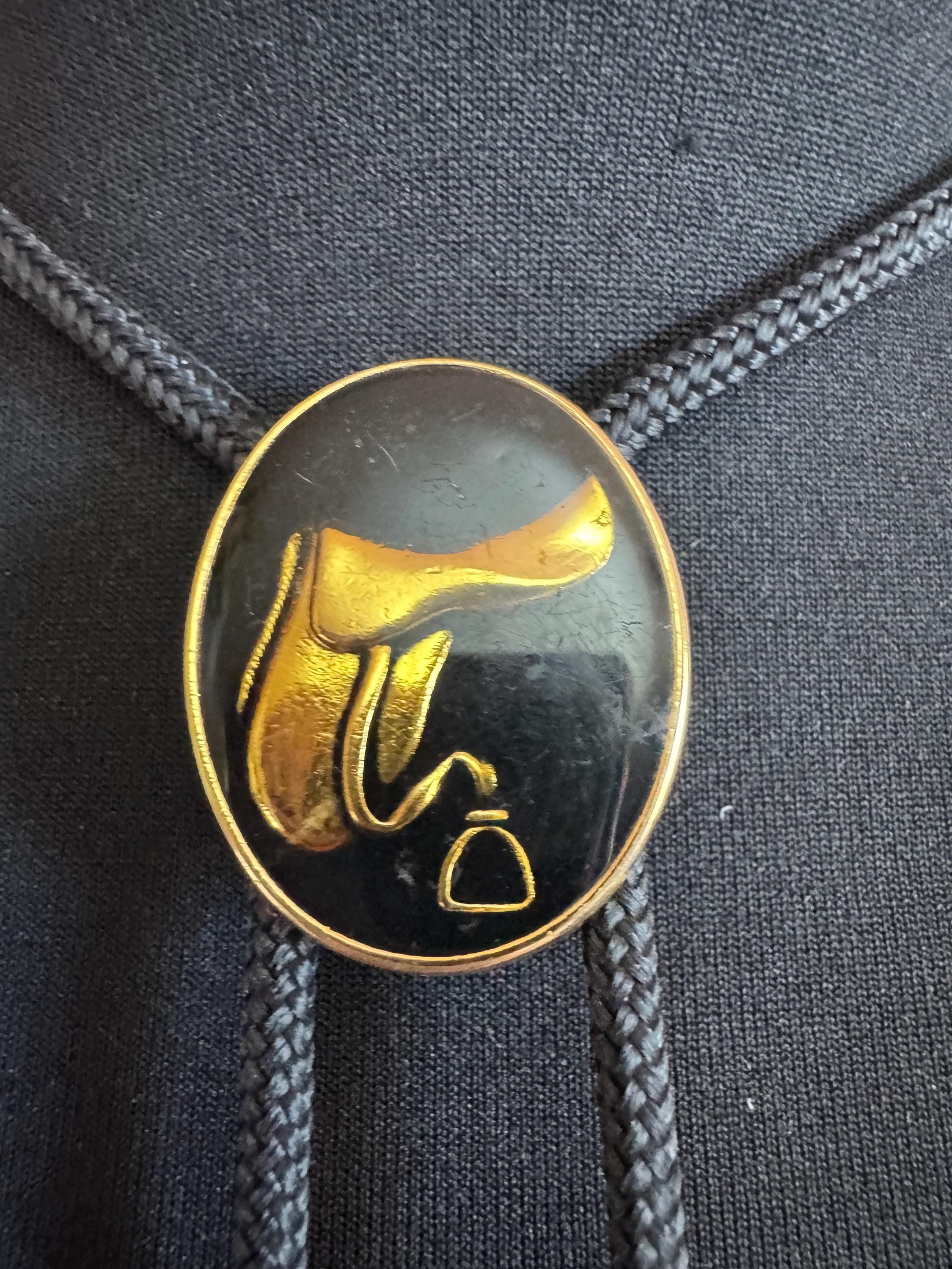 Retro western style gold black enamel horse saddle bolo tie with black woven cord