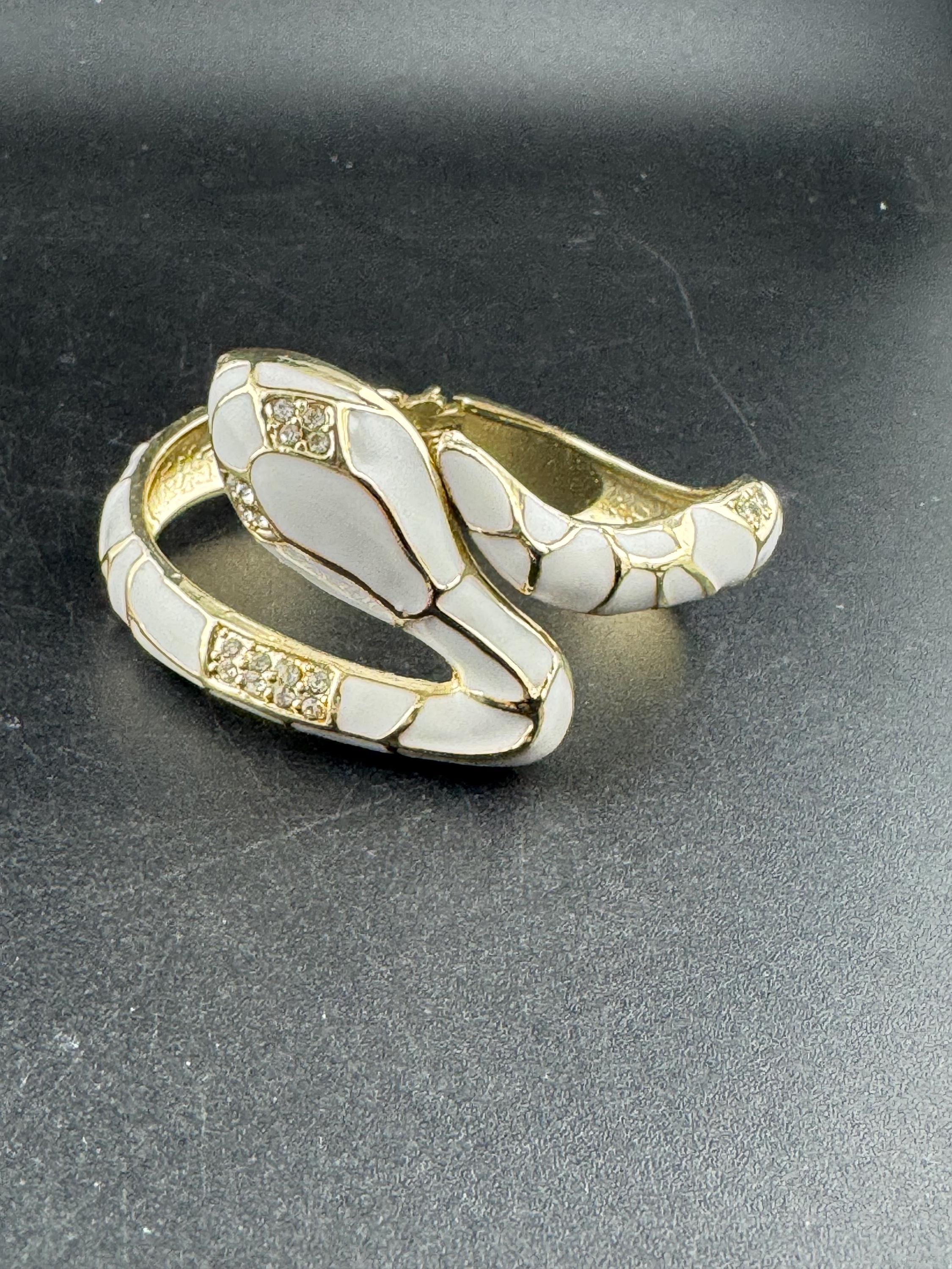 White enamel diamanté hinged snake bangle, clear rhinestone eyes gold tone
