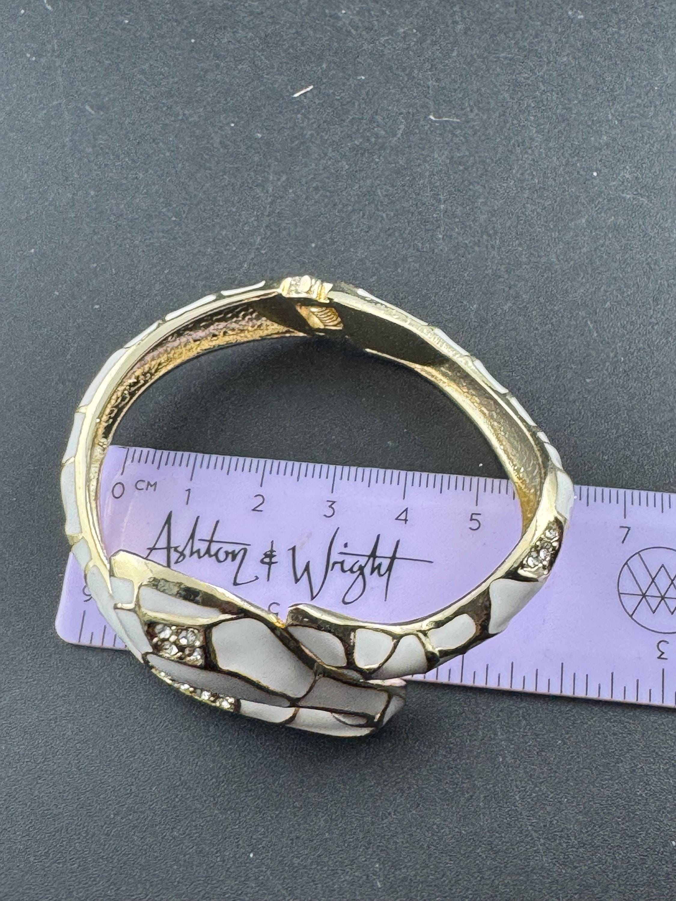 White enamel diamanté hinged snake bangle, clear rhinestone eyes gold tone
