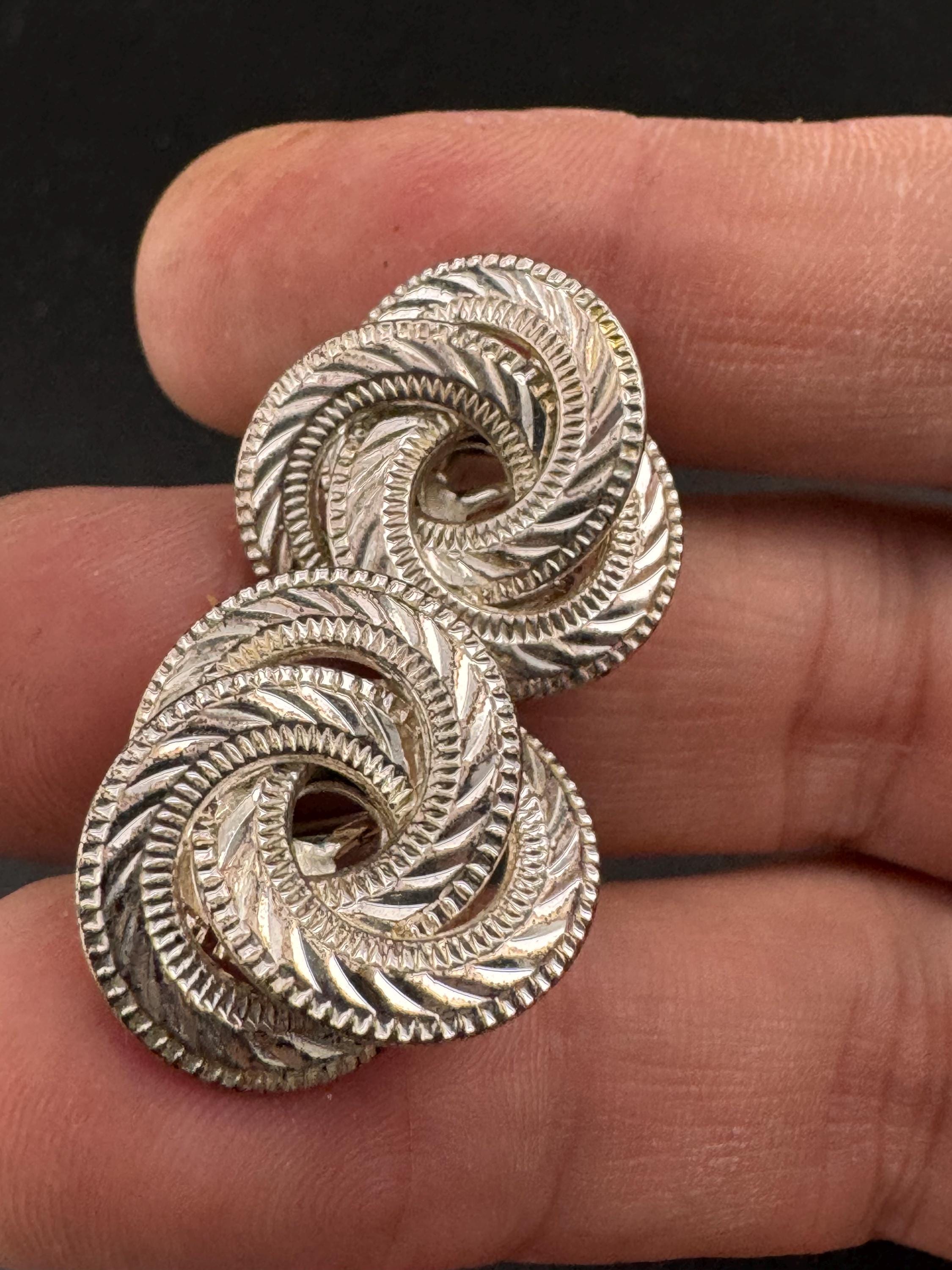 Signed NAPIER swirl knot clip on earrings, silver tone designer