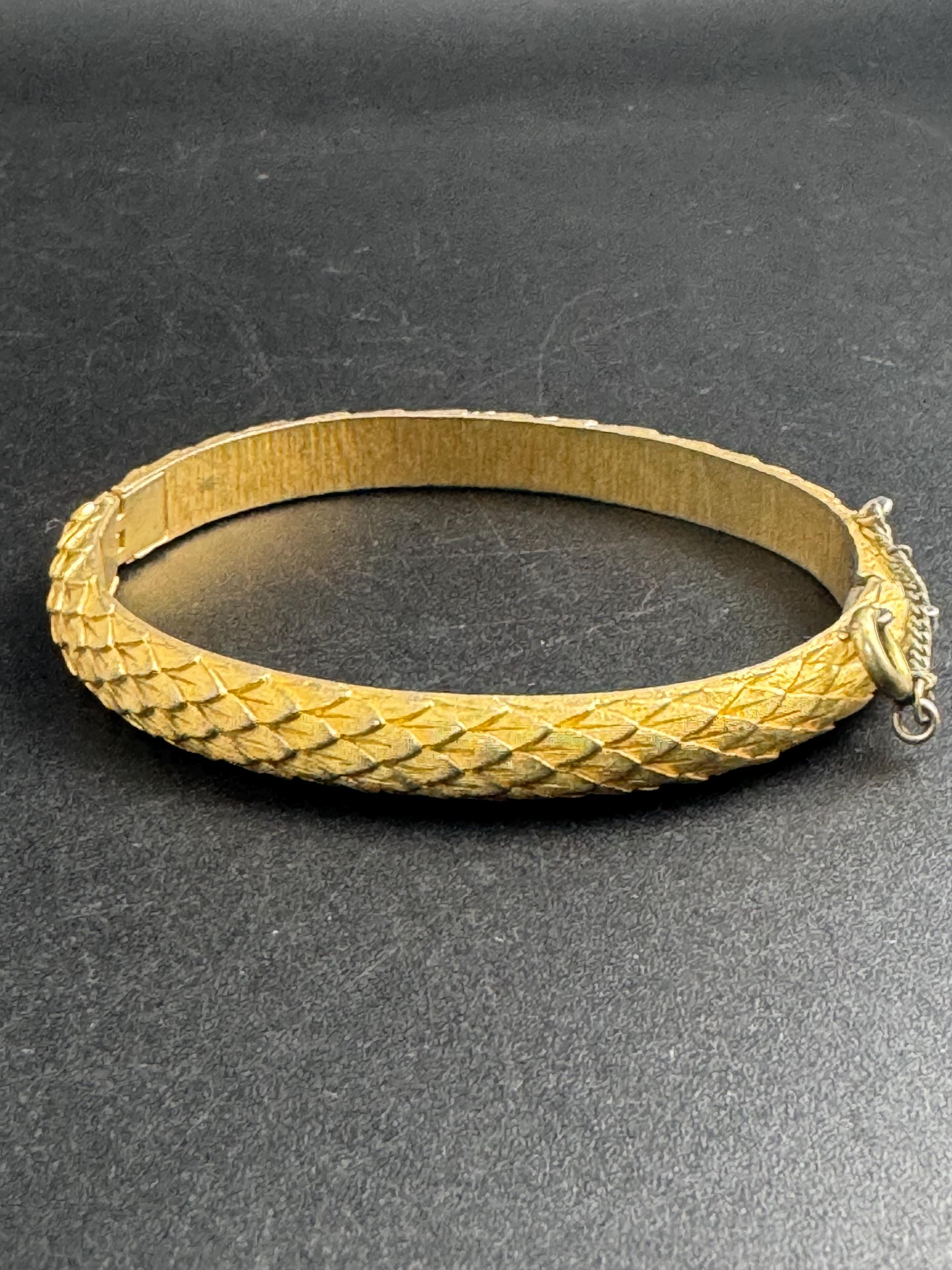 Crown Trifari gold-tone hinged bangle bracelet, textured snake or fish scale pattern