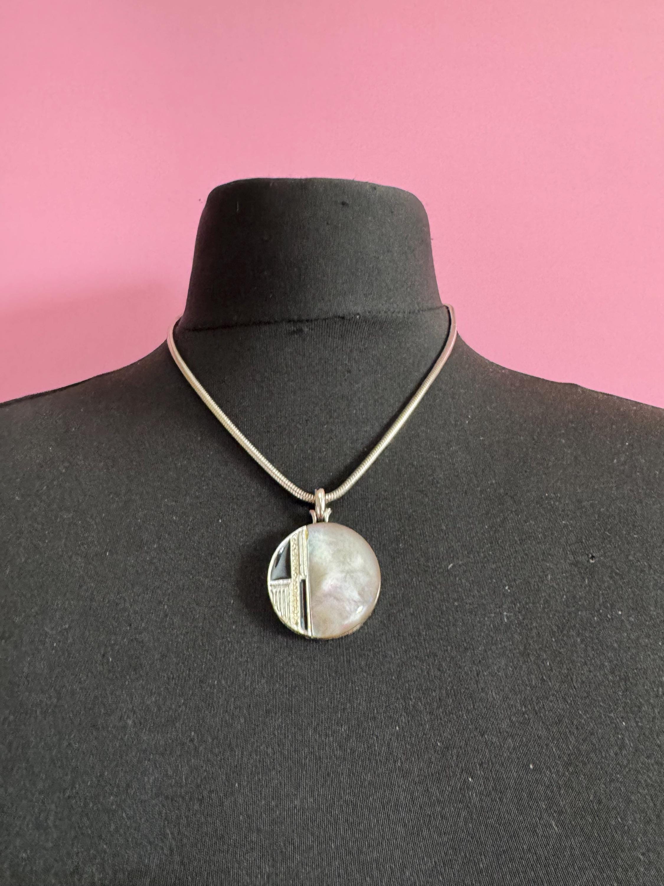 Signed MANDLE black enamel mother of pearl disc pendant on a snake chain necklace