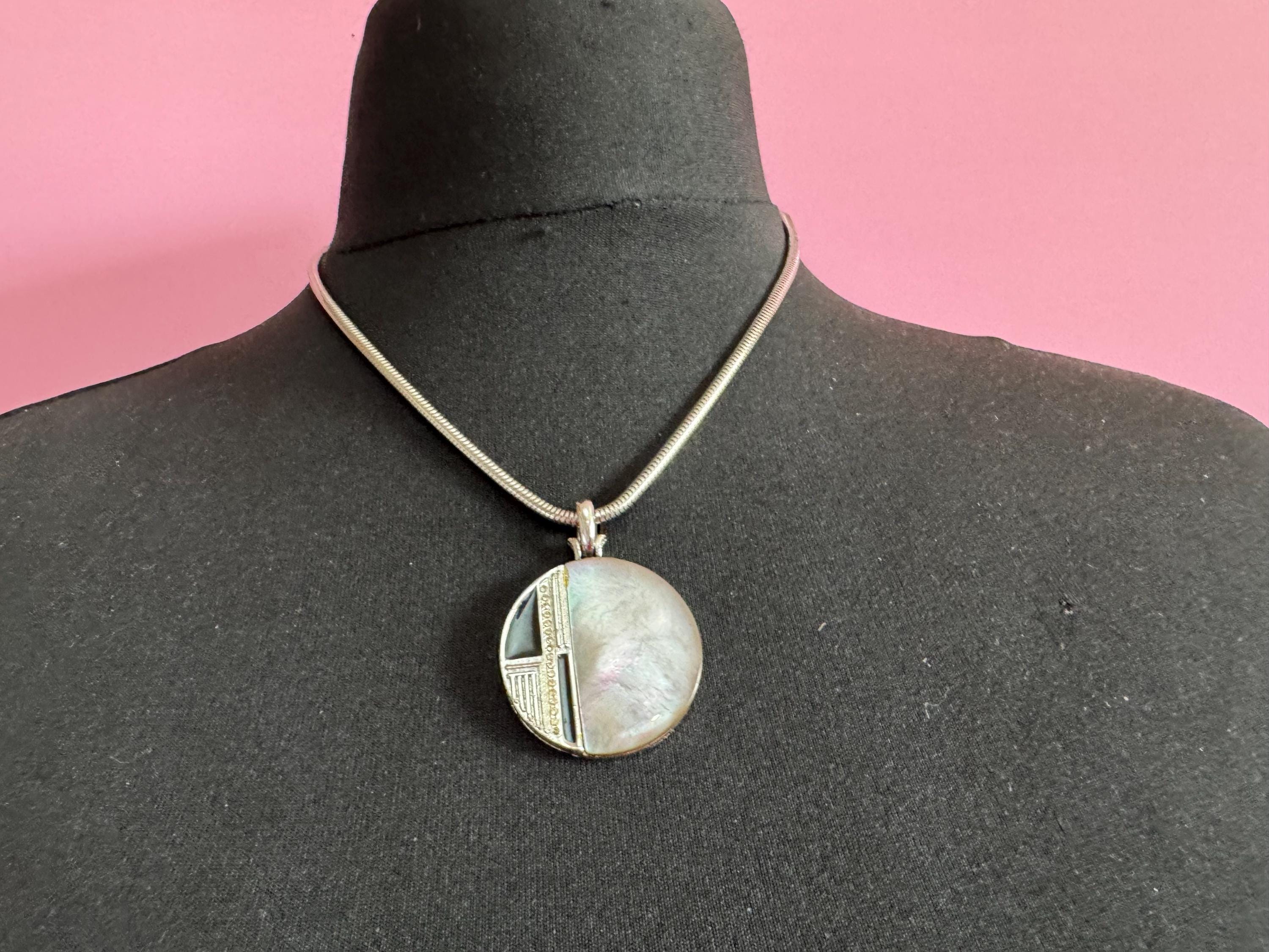 Signed MANDLE black enamel mother of pearl disc pendant on a snake chain necklace