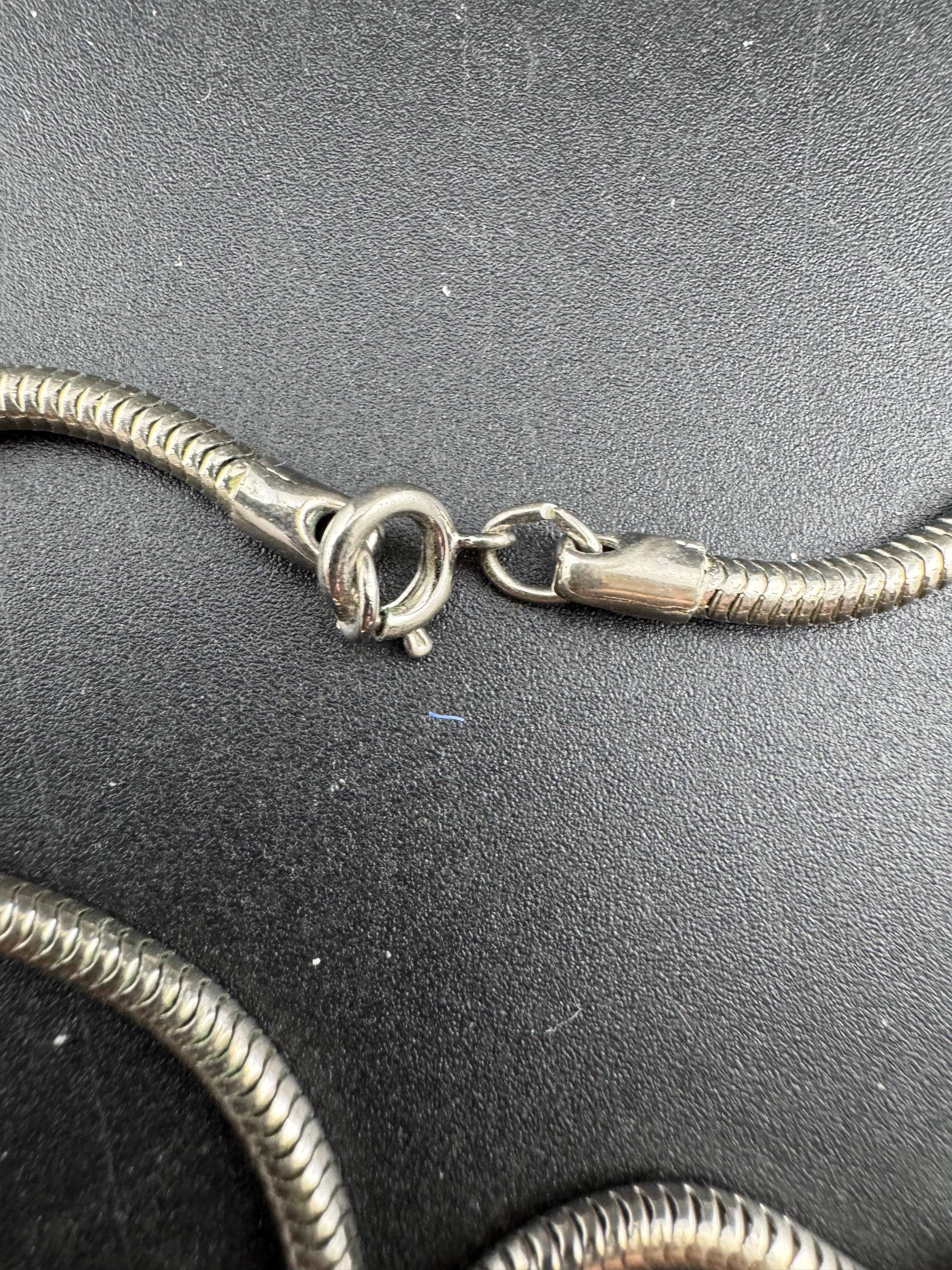 Signed MANDLE black enamel mother of pearl disc pendant on a snake chain necklace