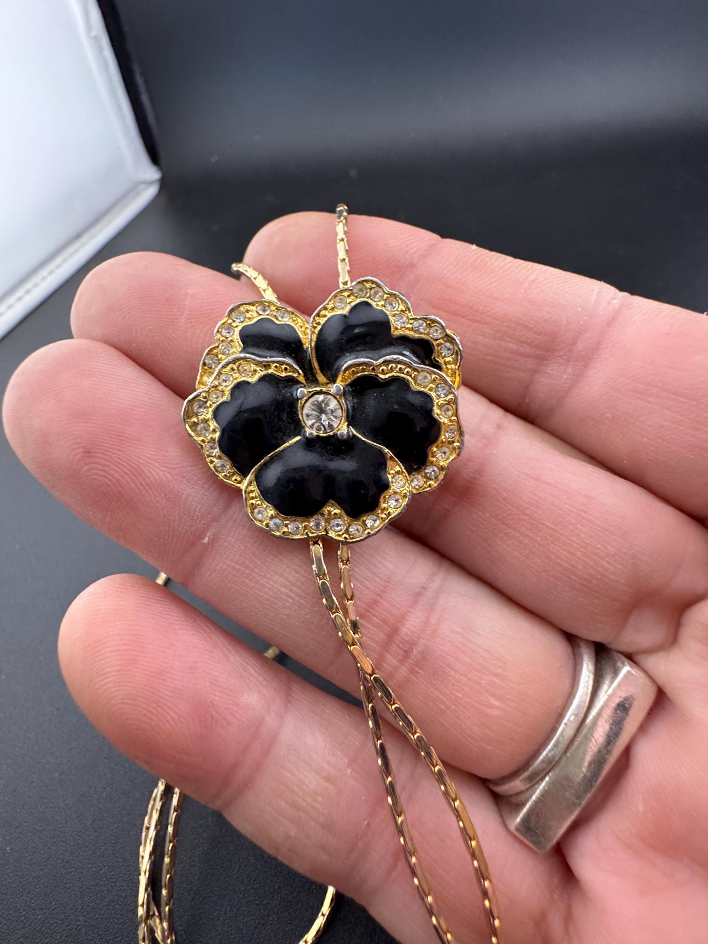 Vintage black enamel and crystal floral slider bolo necklace, with pat no , gold plated