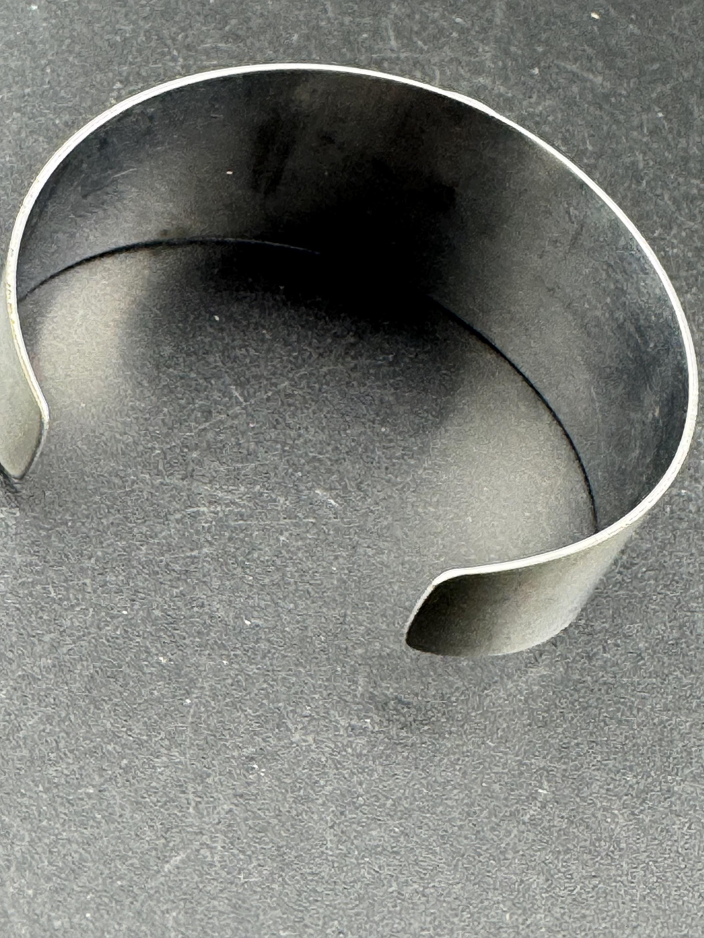 1970s stainless steel wide bangle, set with orange agate genstone