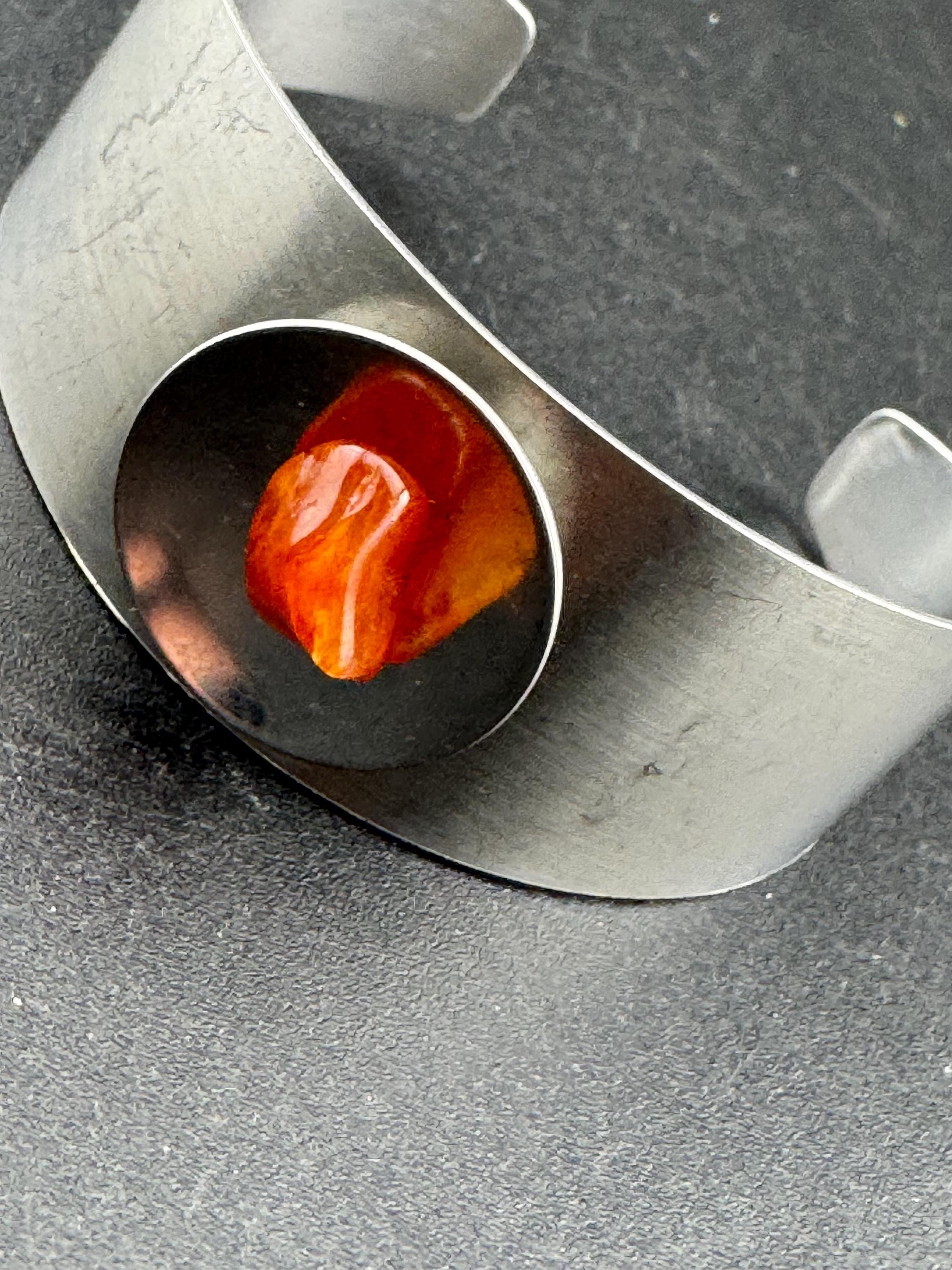 1970s stainless steel wide bangle, set with orange agate genstone