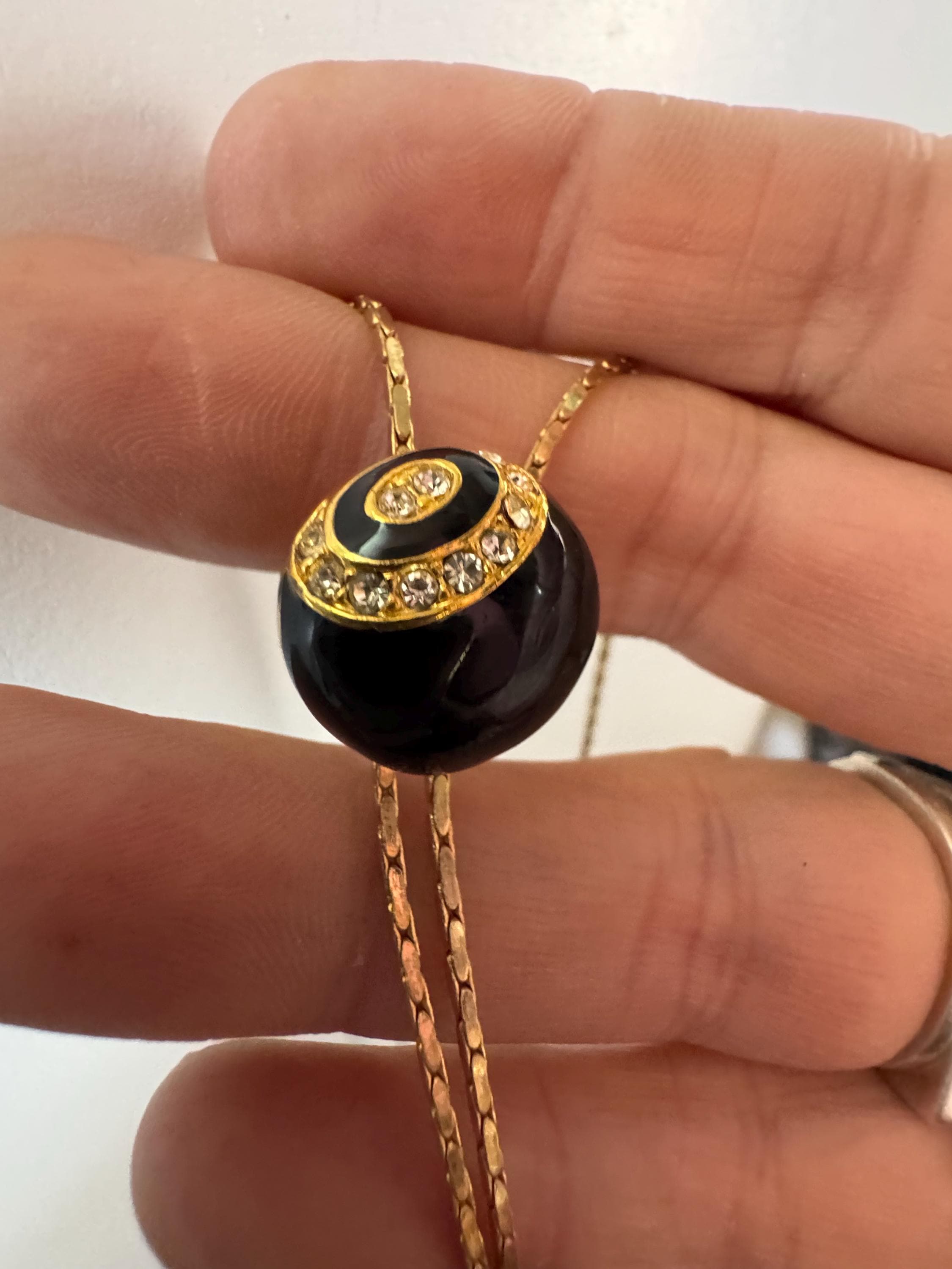 Vintage black enamel and crystal slider bolo necklace, with pat no , gold plated