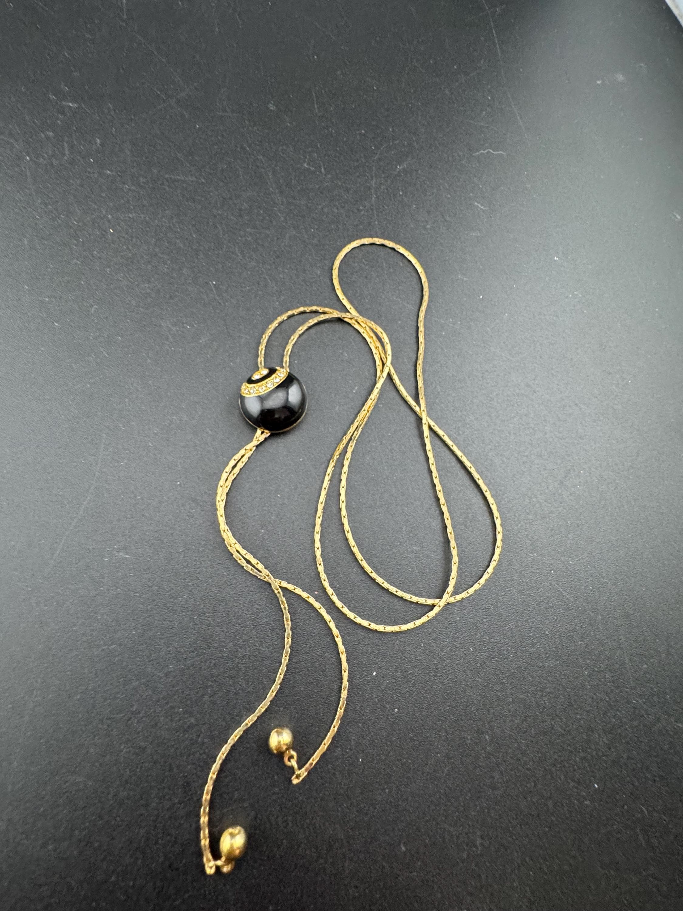 Vintage black enamel and crystal slider bolo necklace, with pat no , gold plated