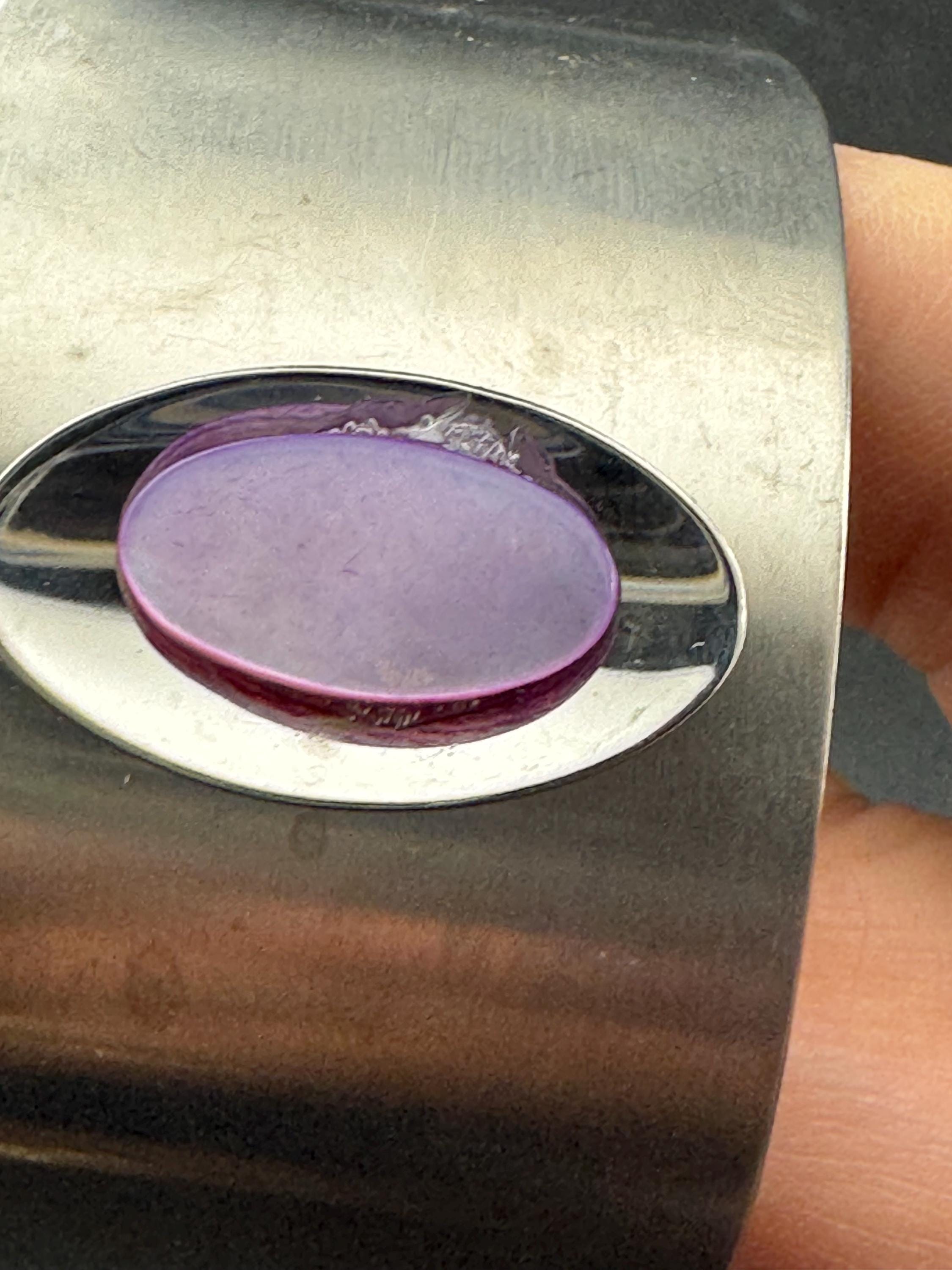1970s stainless steel bangle, set with purple shell cabochon