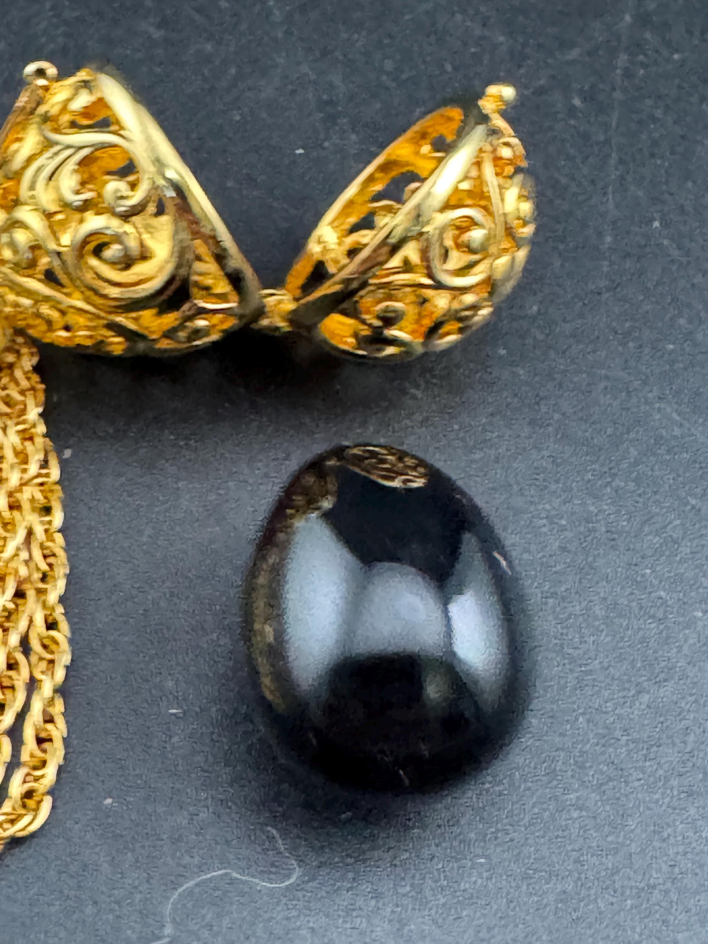 Joan Rivers black egg locket pendant necklace on 75cm chain, Faberge inspired