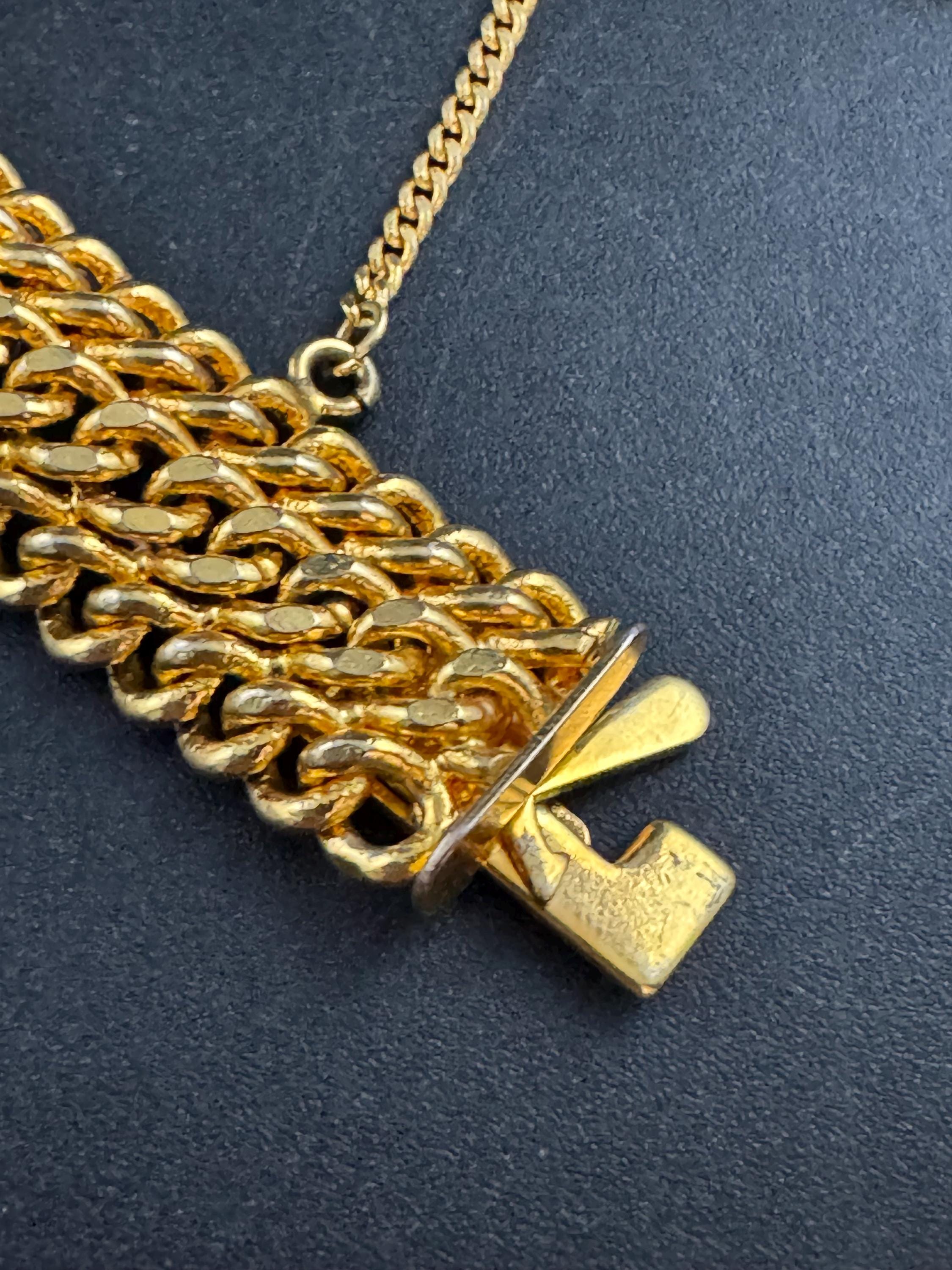 bright gold tone wide woven curb chain bracelet , with safety chain