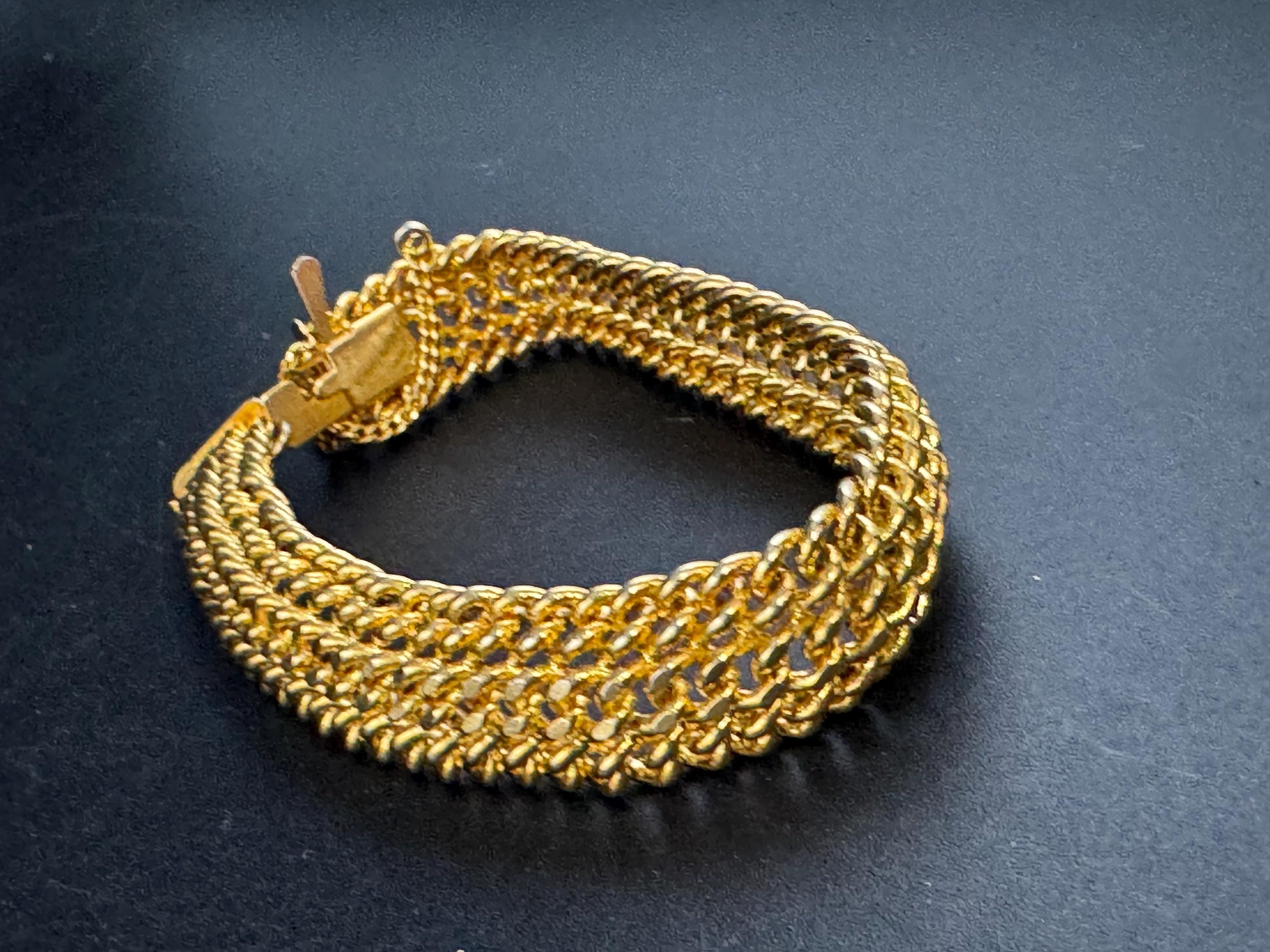 bright gold tone wide woven curb chain bracelet , with safety chain