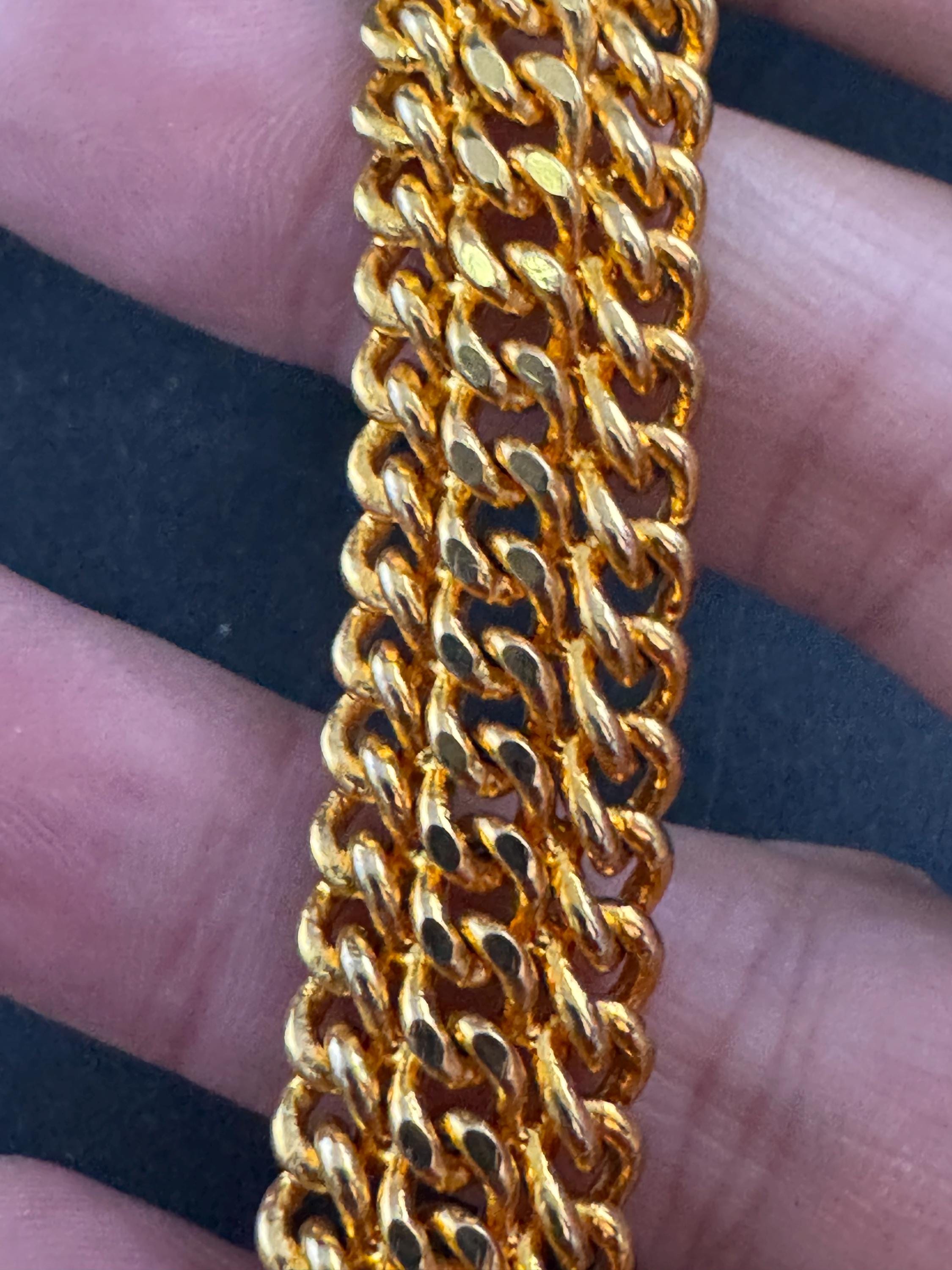 bright gold tone wide woven curb chain bracelet , with safety chain