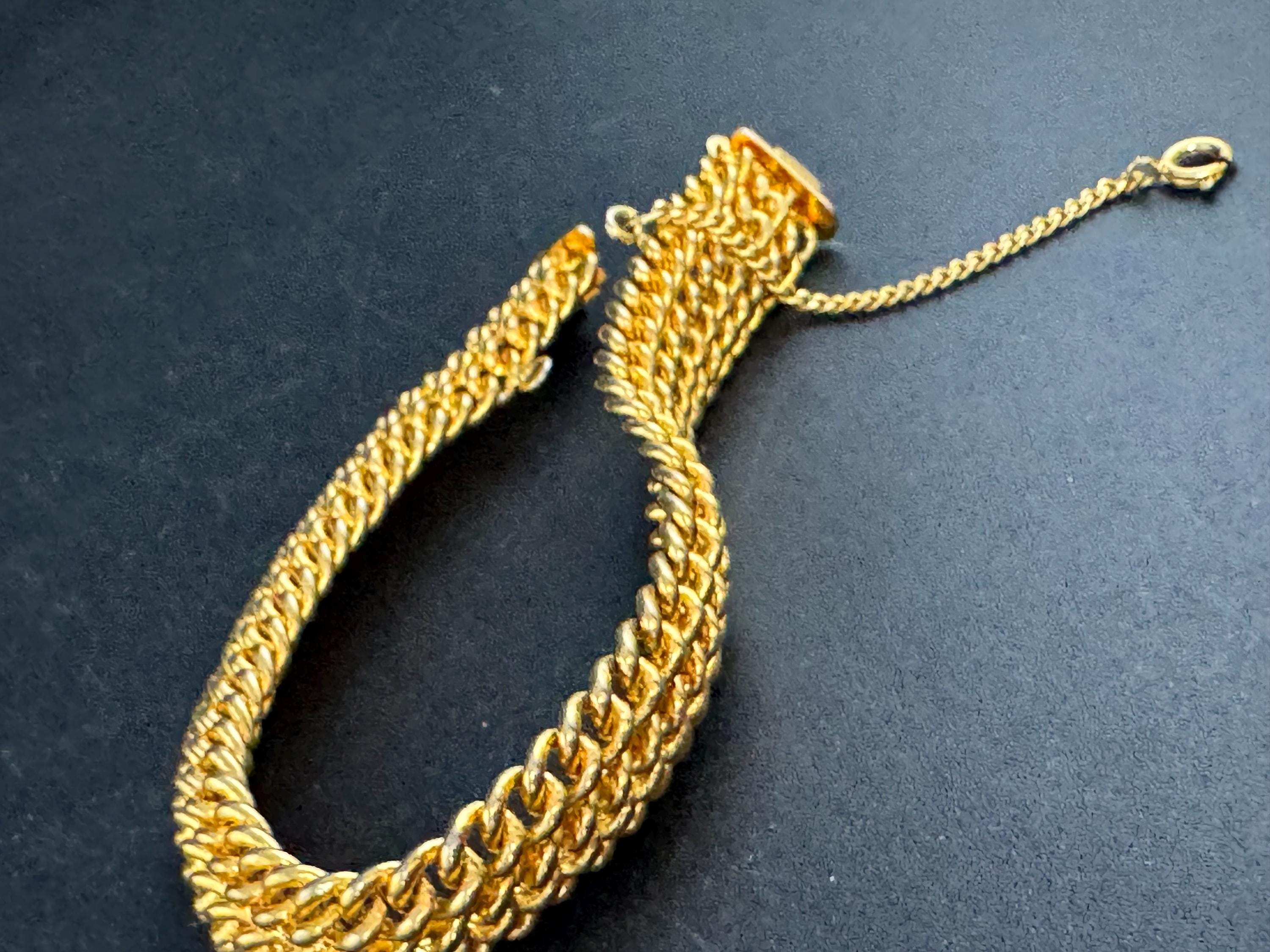 bright gold tone wide woven curb chain bracelet , with safety chain