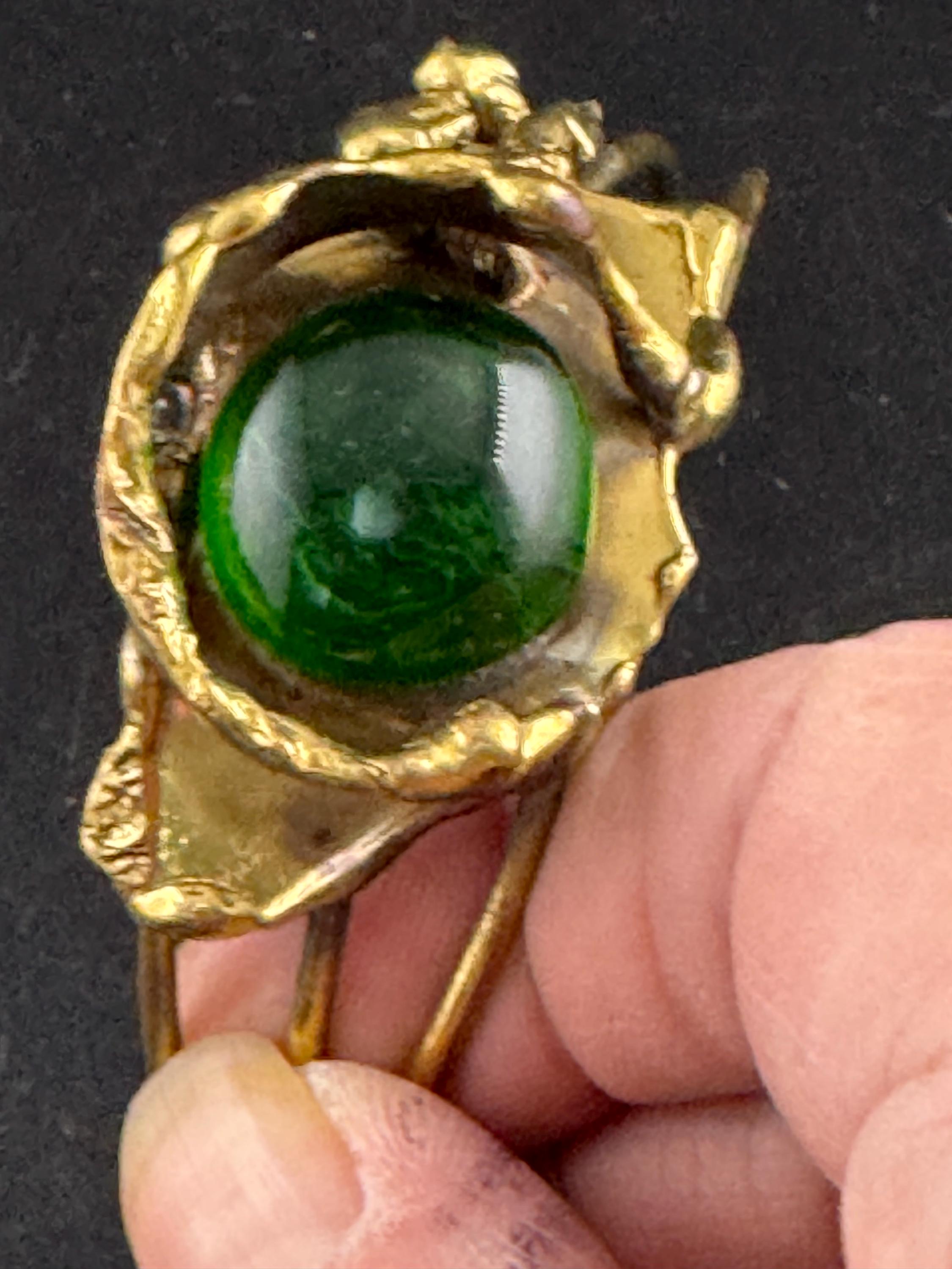 Artisan brass open bangle, set with green glass cabochon